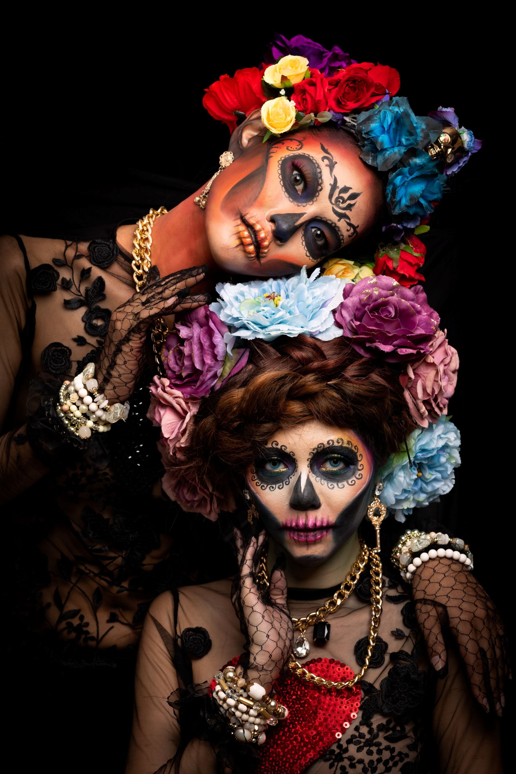 2 women-with-sugar-skull-makeup-dressed-with-flower-crowns