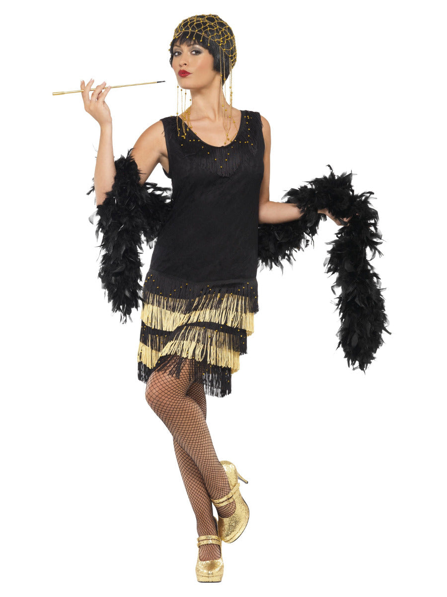 Woman modeling a black 1920s flapper costume with a beaded front, gold-tipped fringe, and a black feather boa.