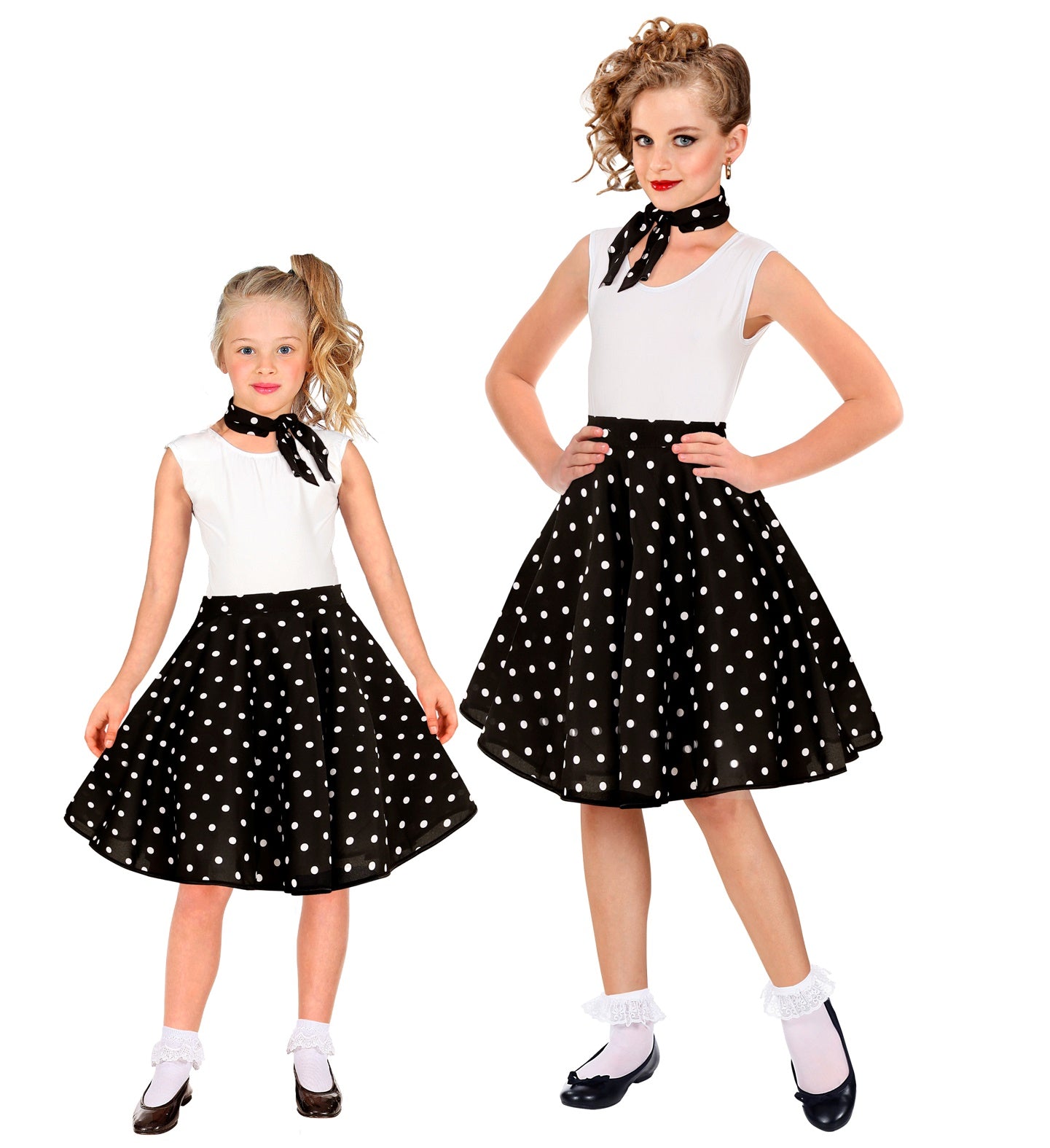 Two girls wearing matching black and white 1950s polka dot skirts and neck scarves.