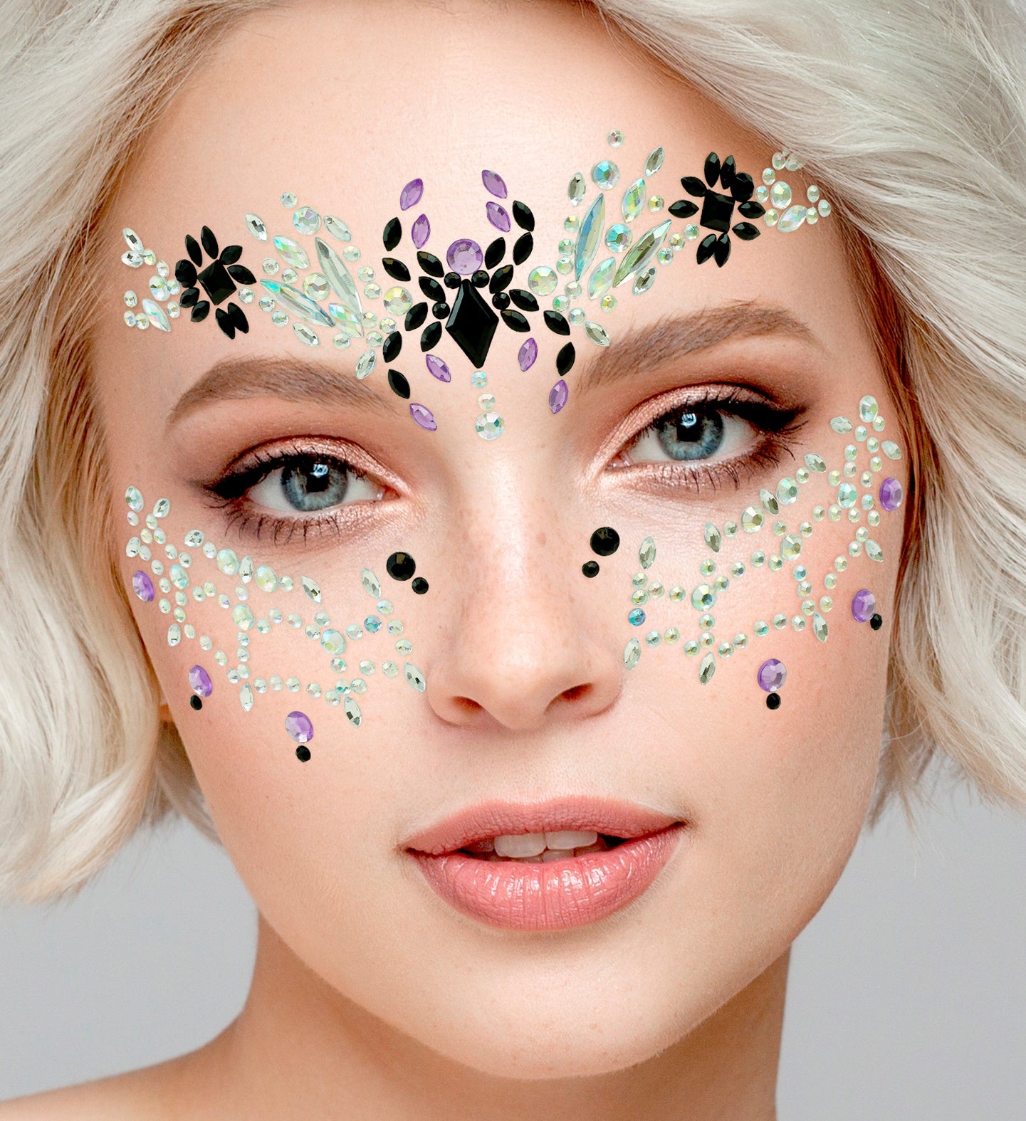 Close-up of a symmetrical black and iridescent crown-style face jewel arrangement for a black widow costume.