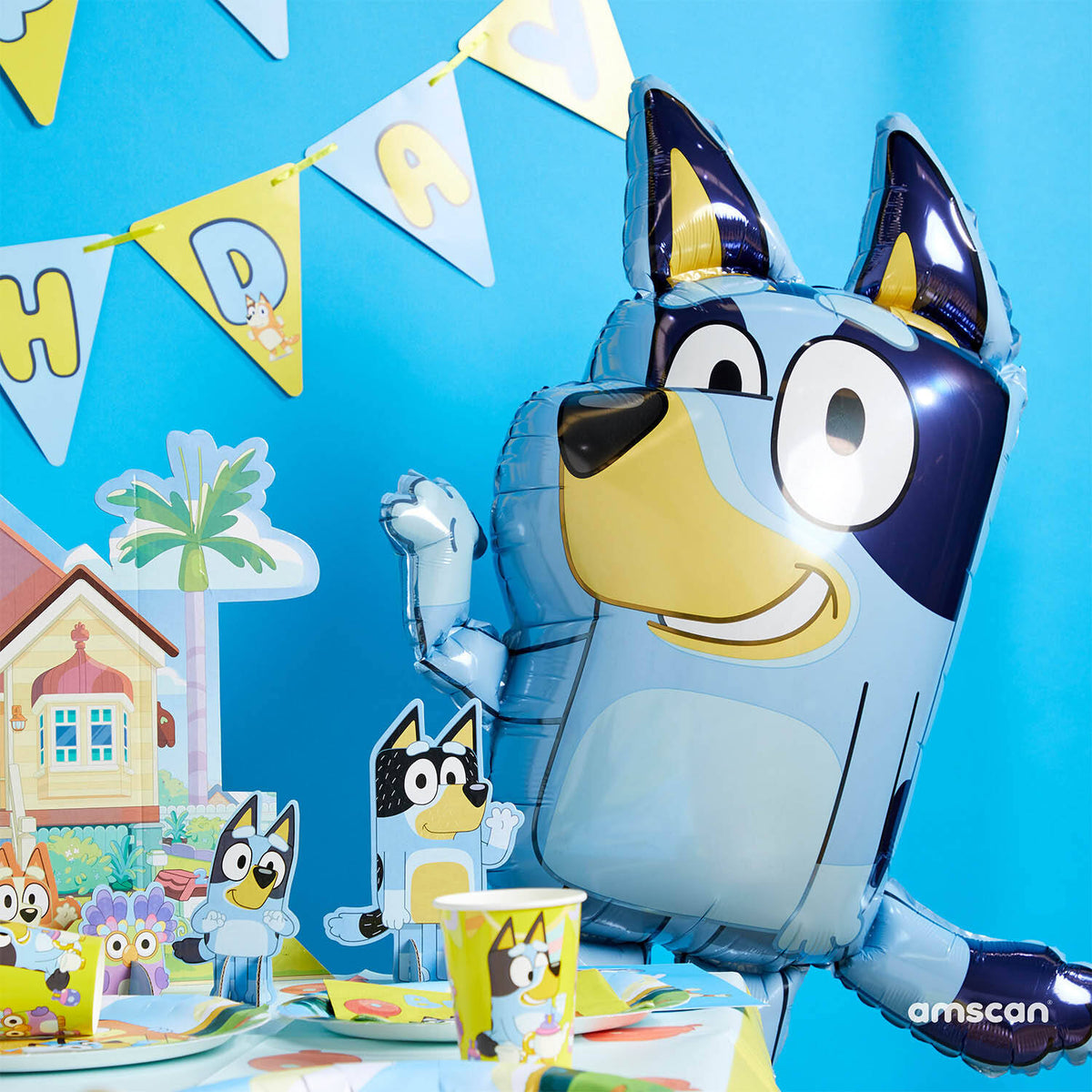Large Bluey character foil balloon waving in a colourful Bluey-themed party display with bunting and decorations.