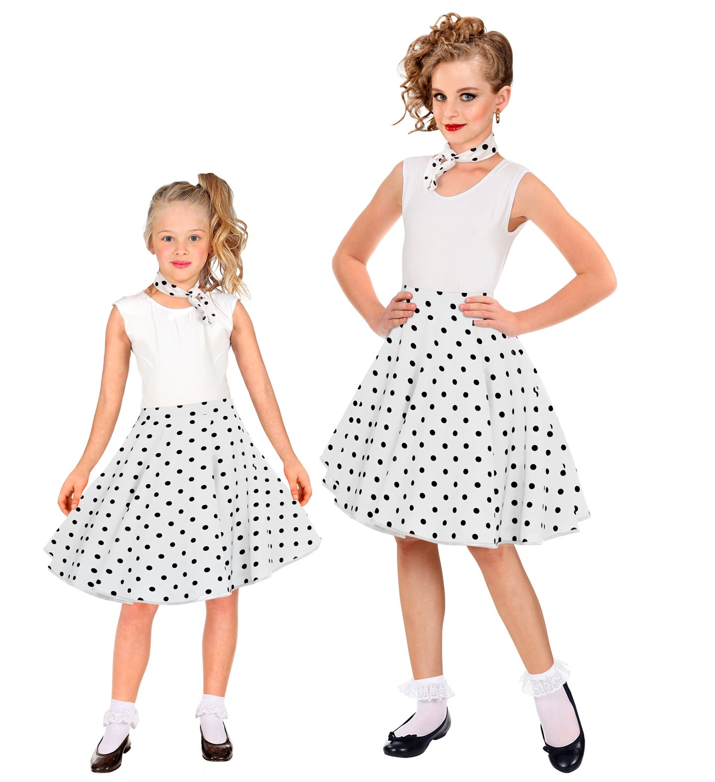 Two girls wearing matching white and black 1950s polka dot skirts and neck scarves.
