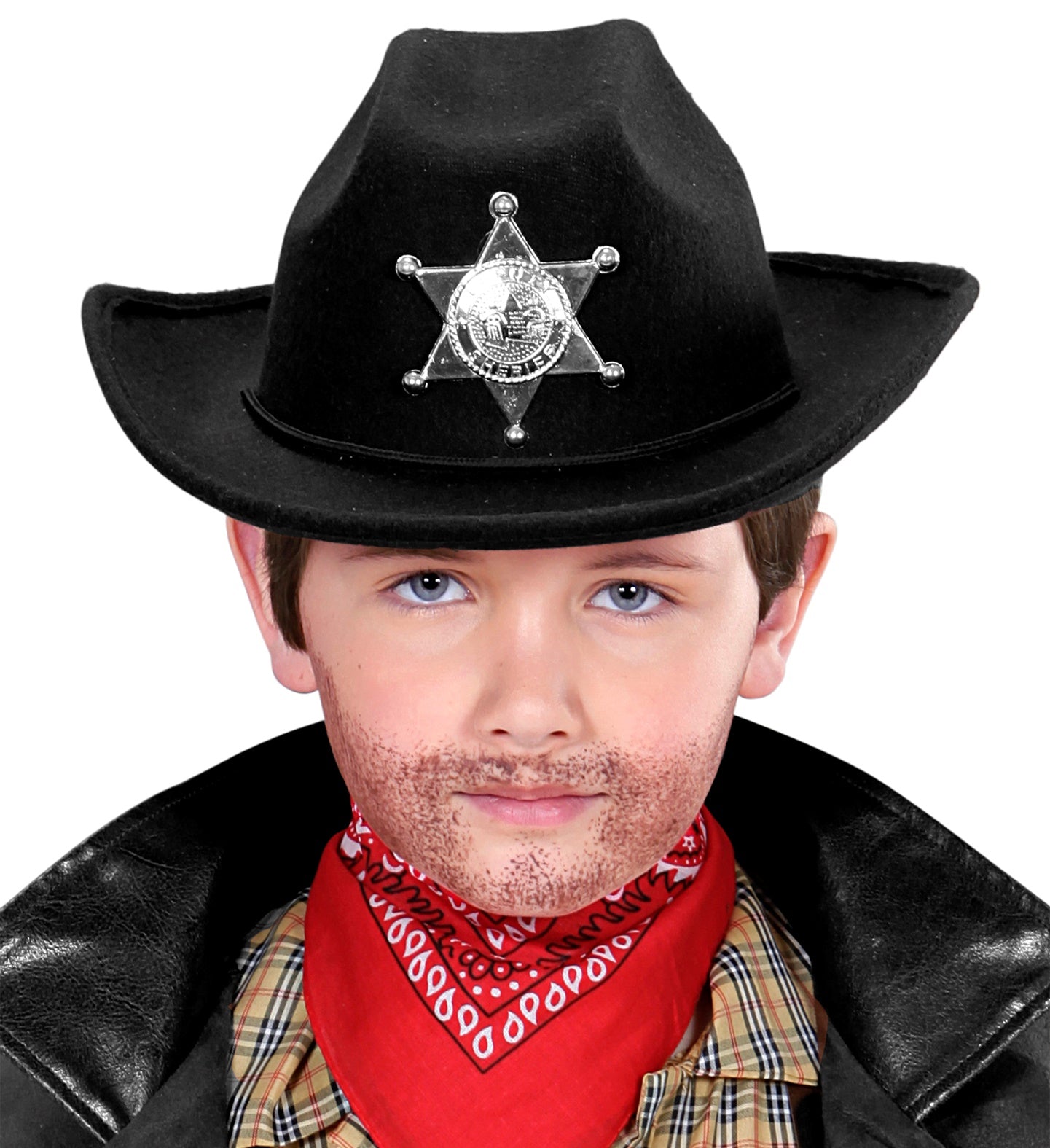 A close-up of a child wearing a black cowboy hat with a silver sheriff's badge on the front, a red bandana, and a plaid shirt. The child has painted stubble on their face and is looking directly at the camera.