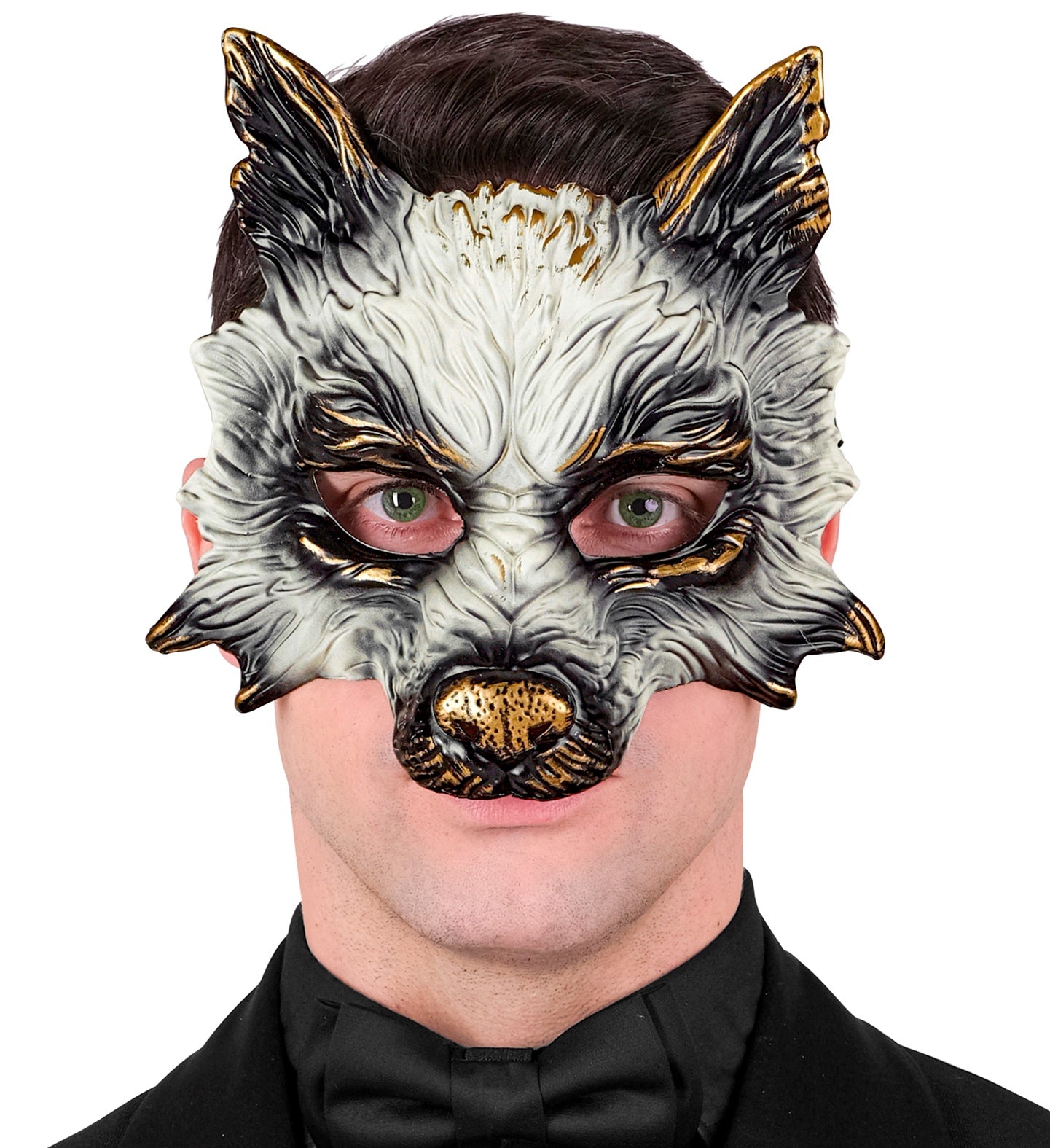 A man with green eyes wearing a white and gold wolf mask, paired with a black tuxedo and bow tie for a formal look.