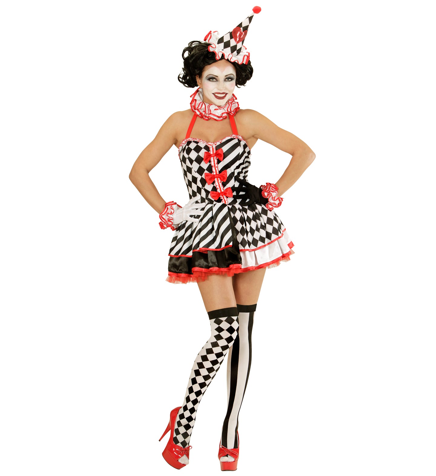 A model wearing a complete circus jester costume including a diamond-patterned dress, mini hat, and mismatched harlequin thigh-high stockings.