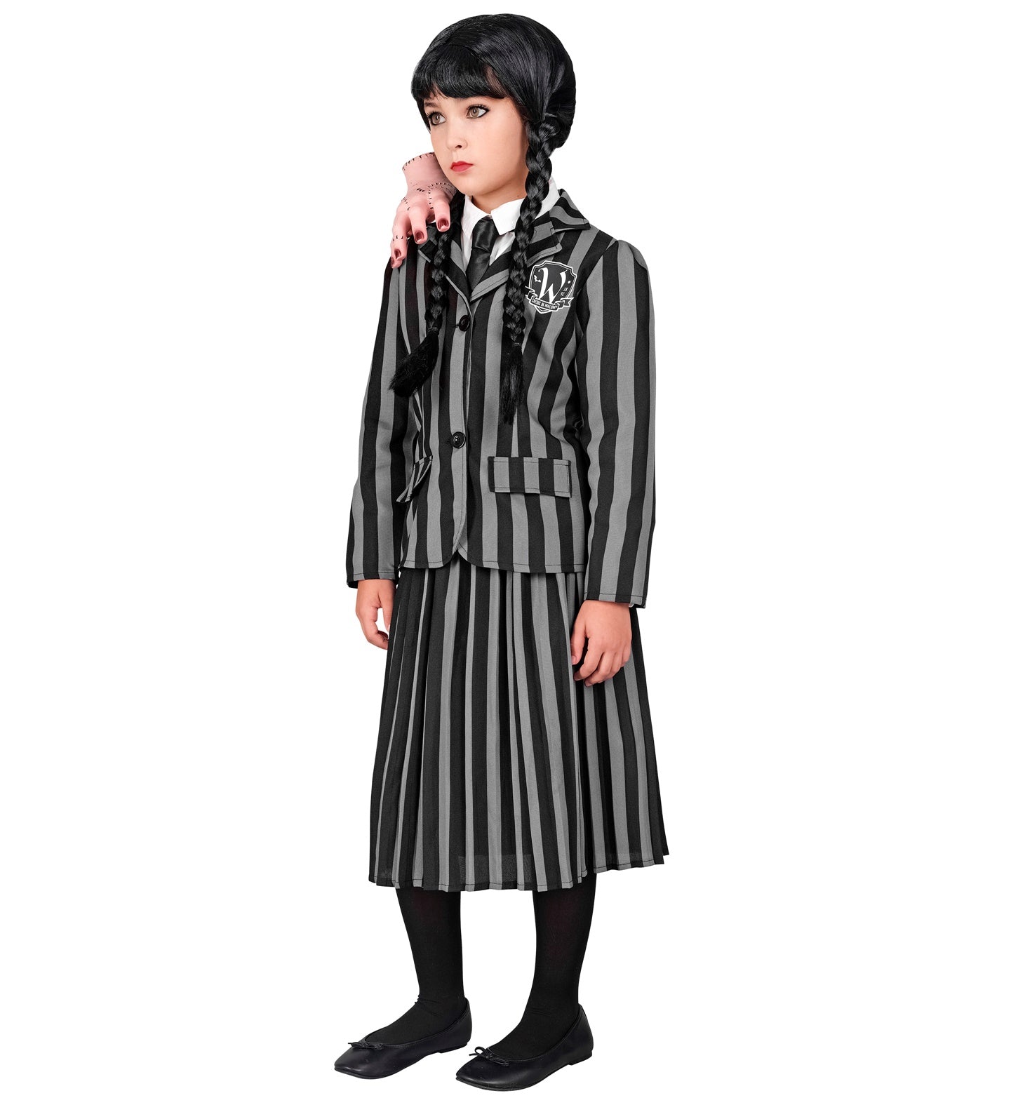 Side view of a child wearing a Wednesday Addams style school uniform, featuring the striped jacket and skirt, with a prop hand on her shoulder.