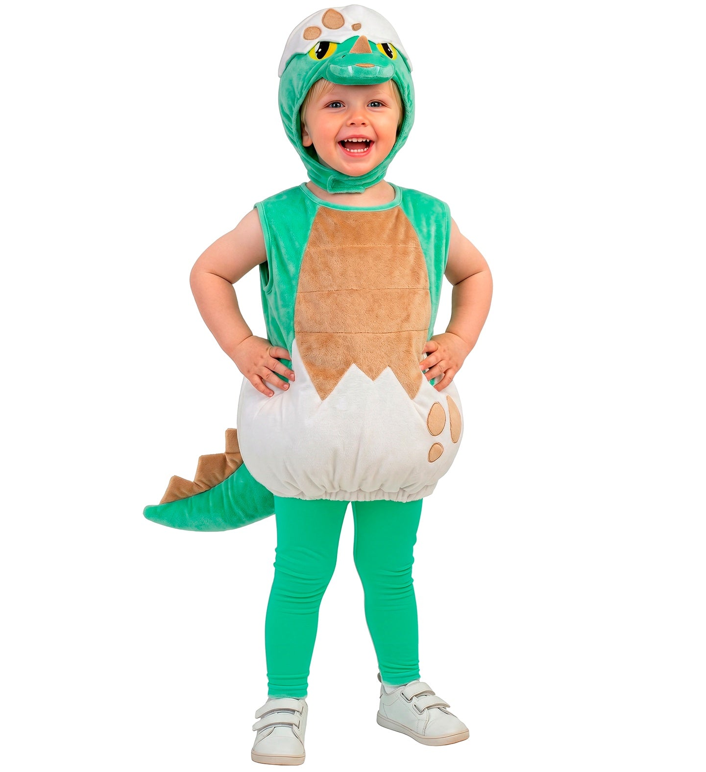 A child standing happily with hands on hips, modeling a sleeveless green plush baby dinosaur costume with a printed eggshell pattern on the bottom.