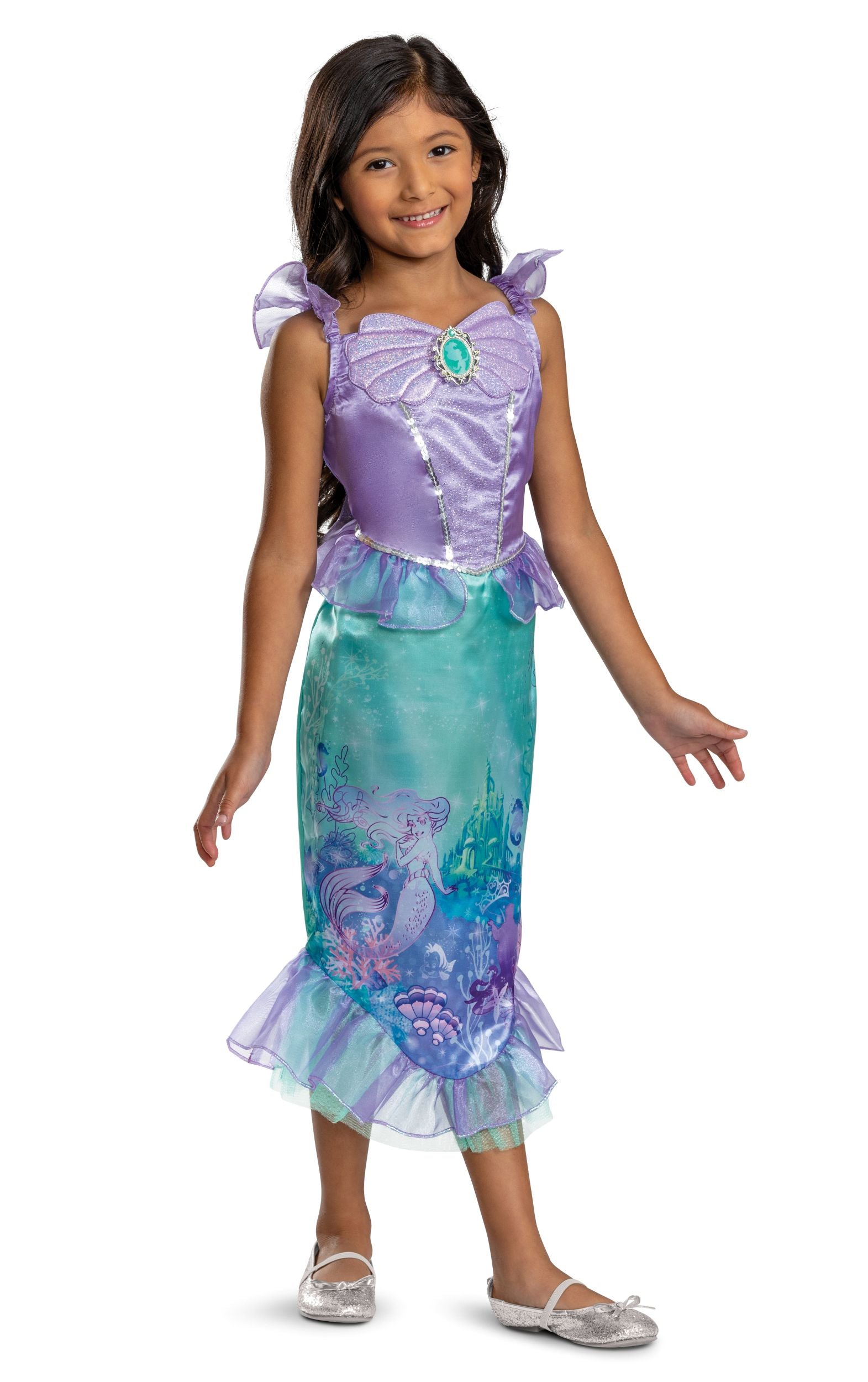 A model wearing an officially licensed Disney Princess Ariel costume featuring a purple bodice with a shell cameo, sheer flutter sleeves, and a teal mermaid skirt showcasing an underwater storybook print.