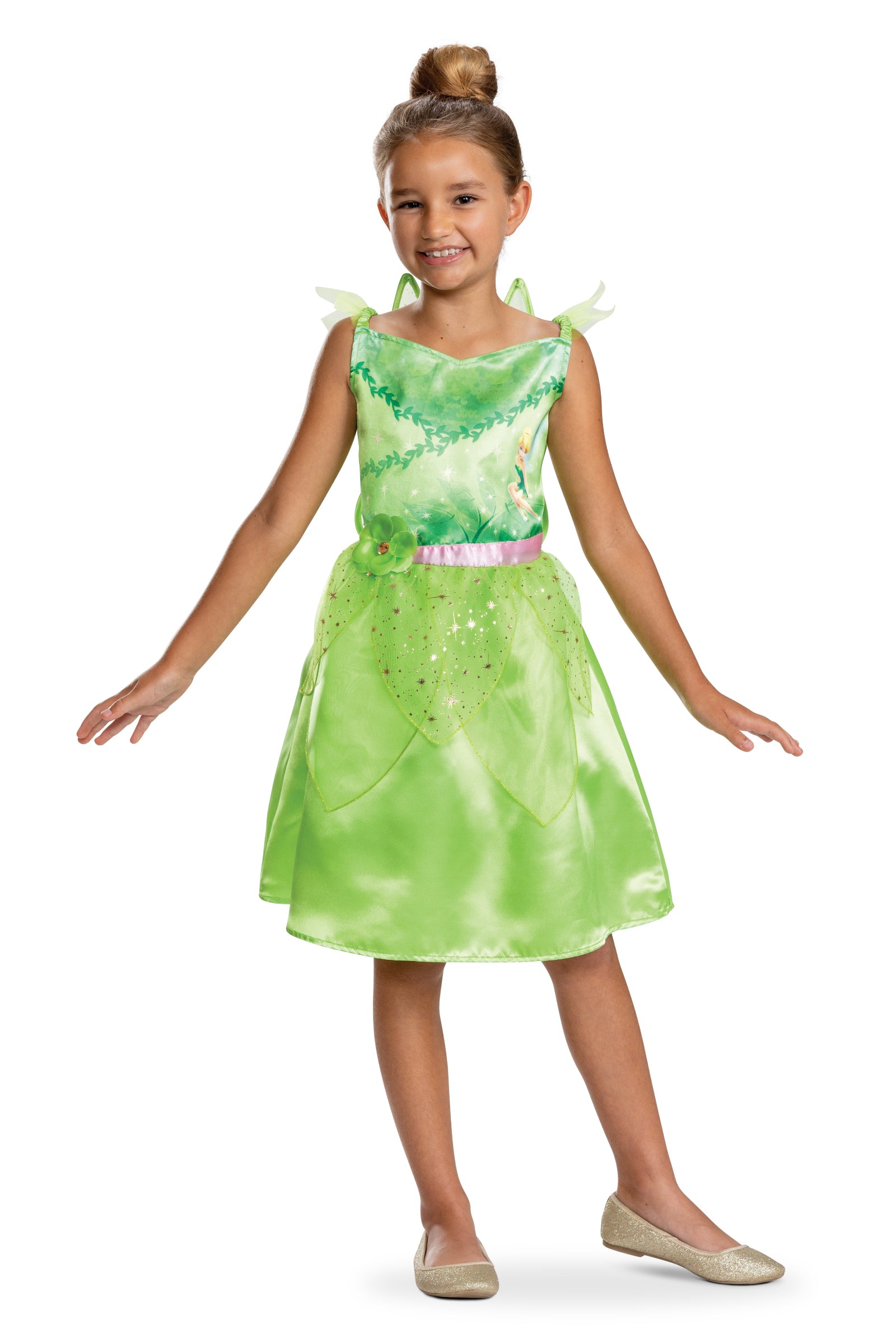 A girl wearing an officially licensed Disney Tinkerbell costume featuring a green dress with a character print, a pink waist sash with a green flower, and a sparkly sheer leaf peplum, posing with arms outstretched.