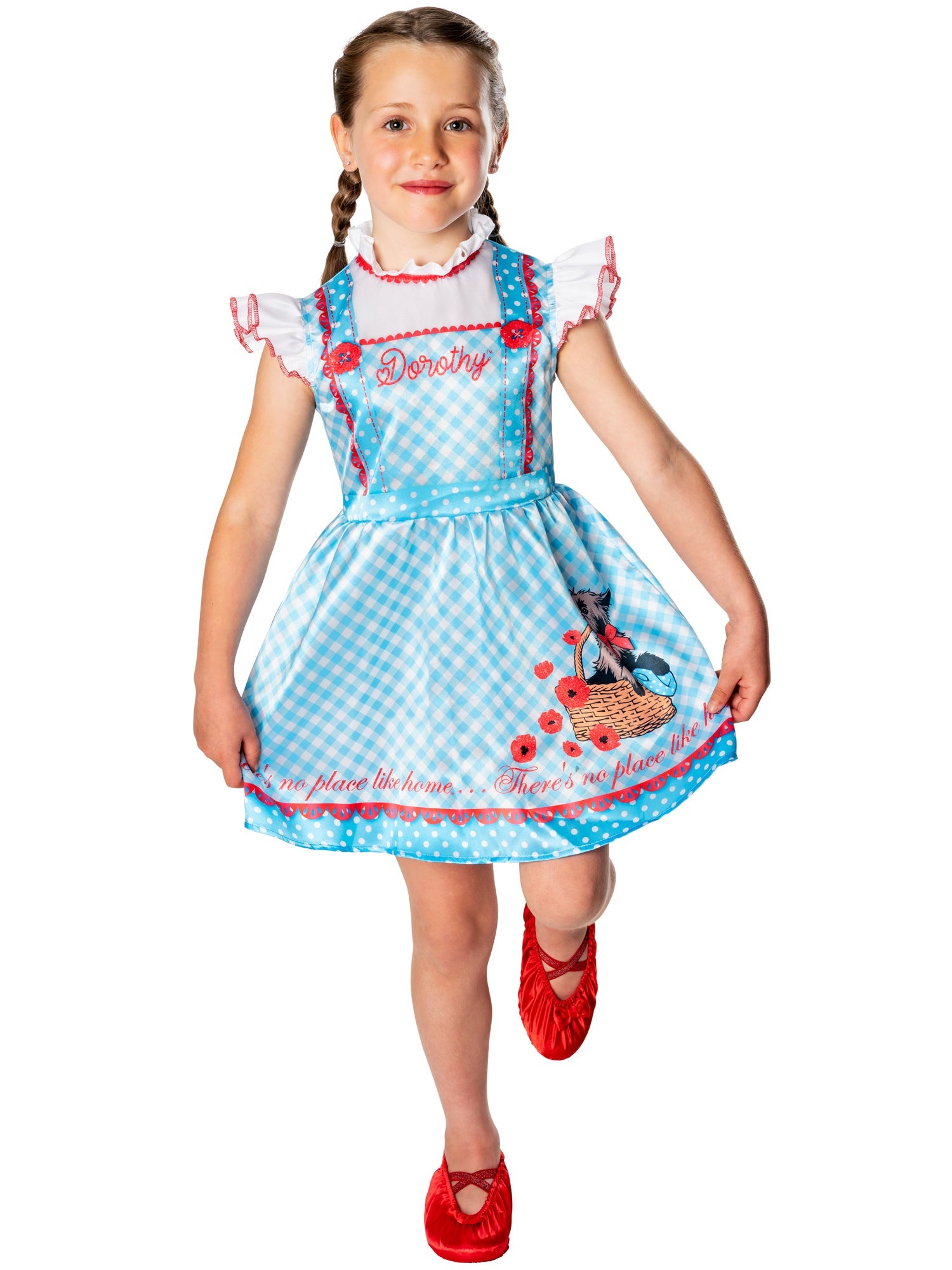 Happy child posing in the Dorothy Wizard of Oz dress and red shoe covers.