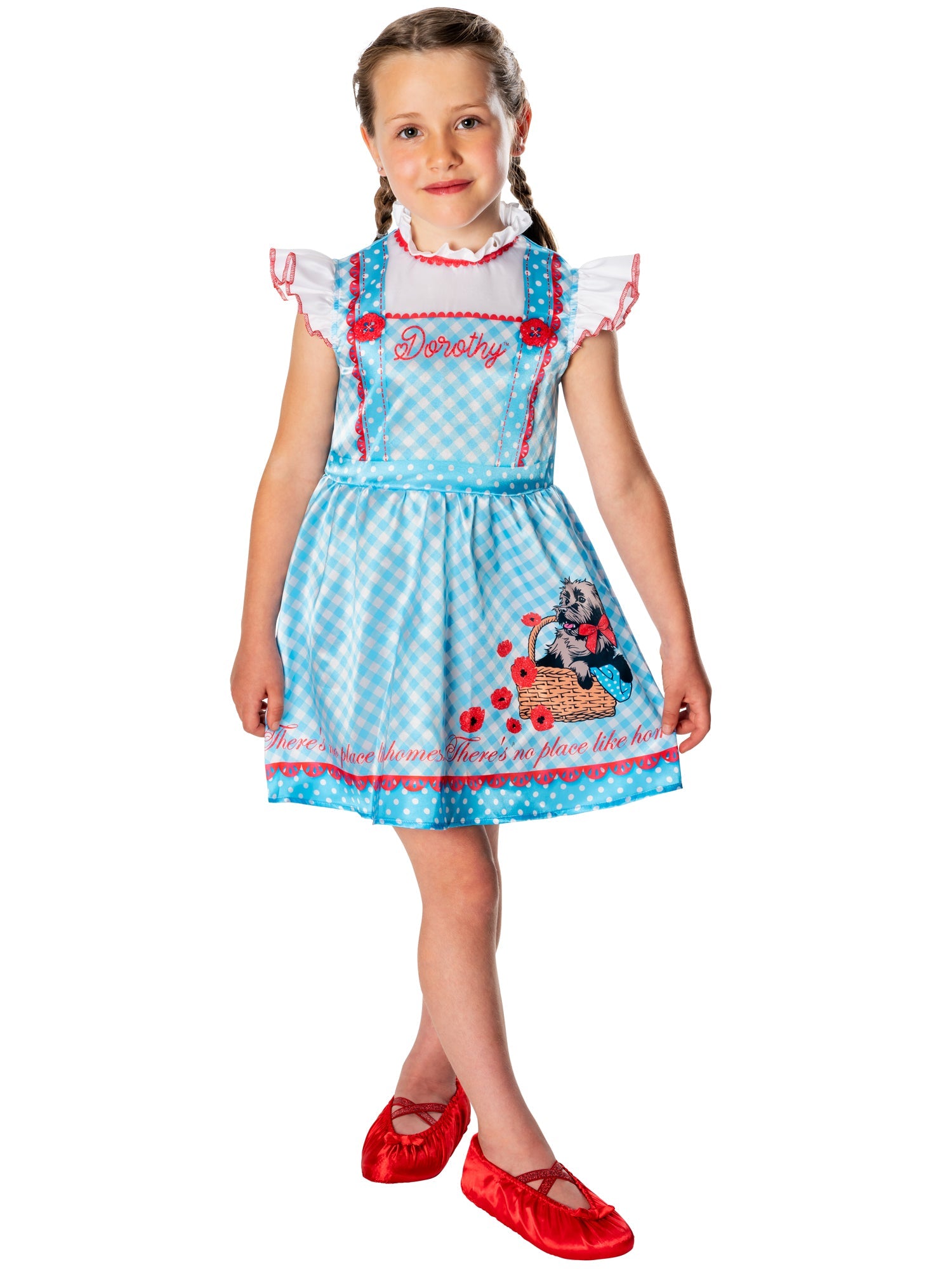Child wearing a blue dress with red shoes on a white background