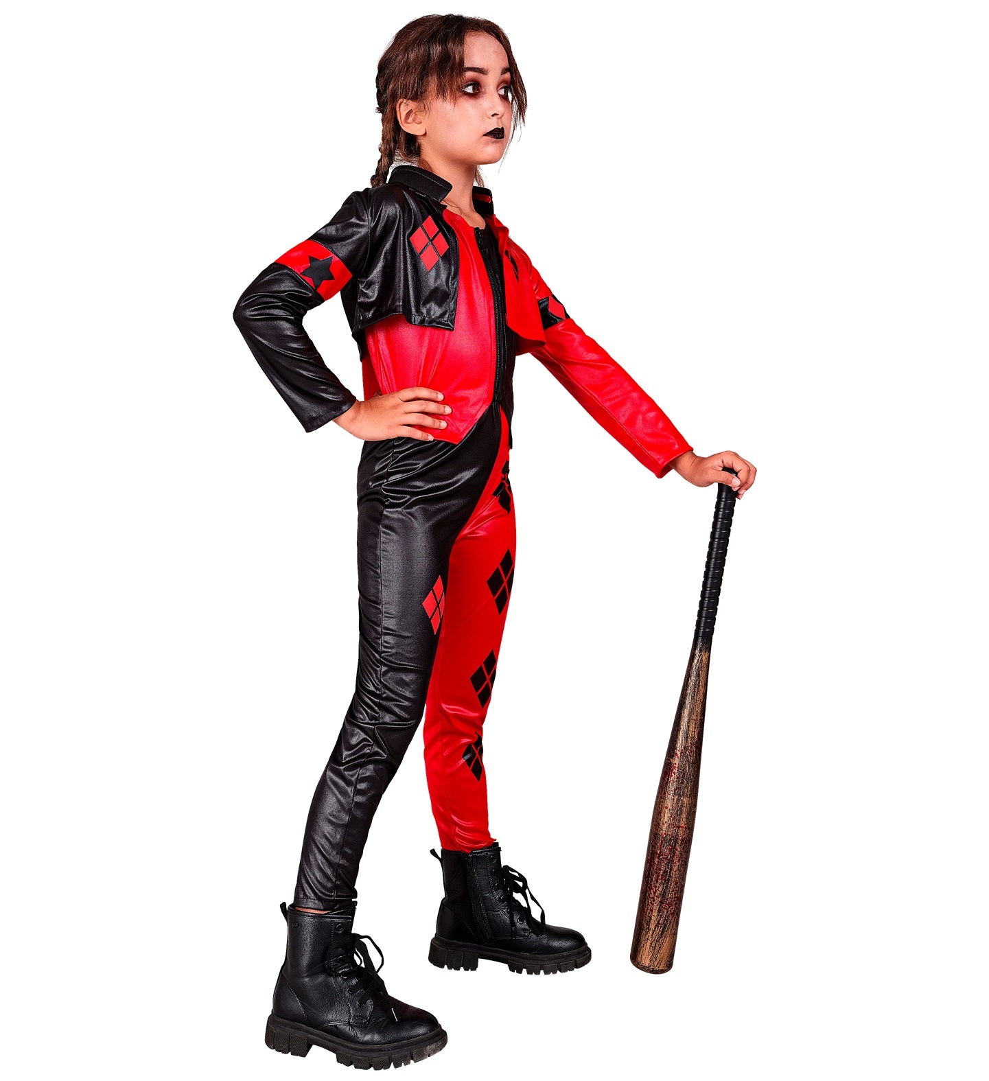 A child in a red and black harlequin costume, seen from the side, standing with one hand on her hip and a toy baseball bat resting on the ground next to her. She has black clown makeup on her mouth.