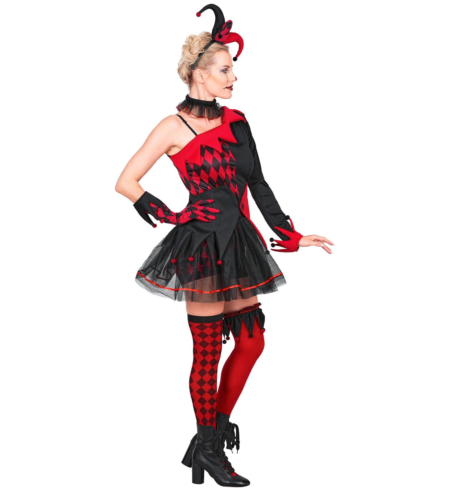 A side-profile shot of a female model wearing a gothic harlequin jester costume, highlighting the fit of the asymmetrical checkered dress, the puff sleeves, the waist belt, and the matching glove.