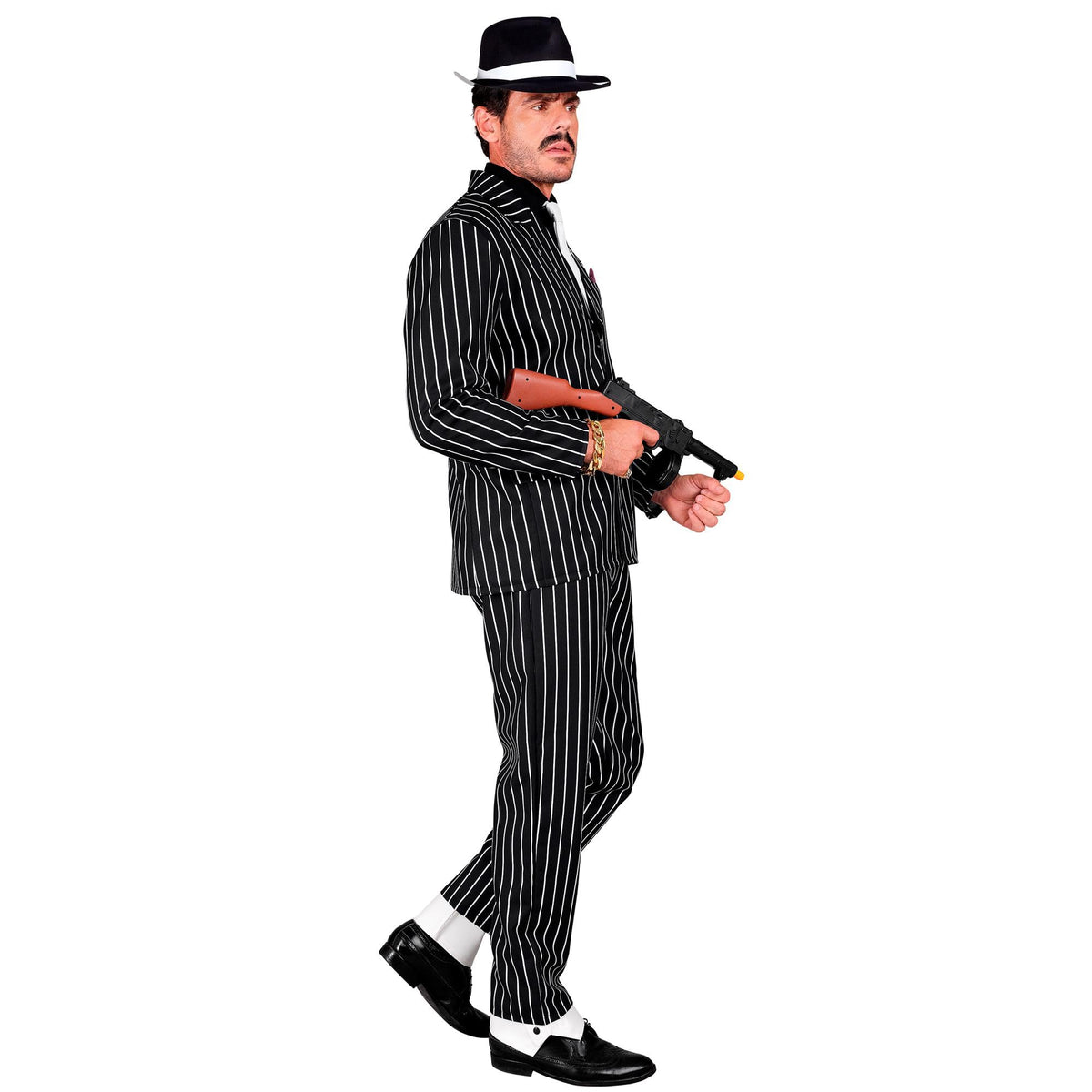 A side profile of a man wearing a classic black and white gangster pinstripe suit with a white tie, walking forward while holding a toy machine gun.
