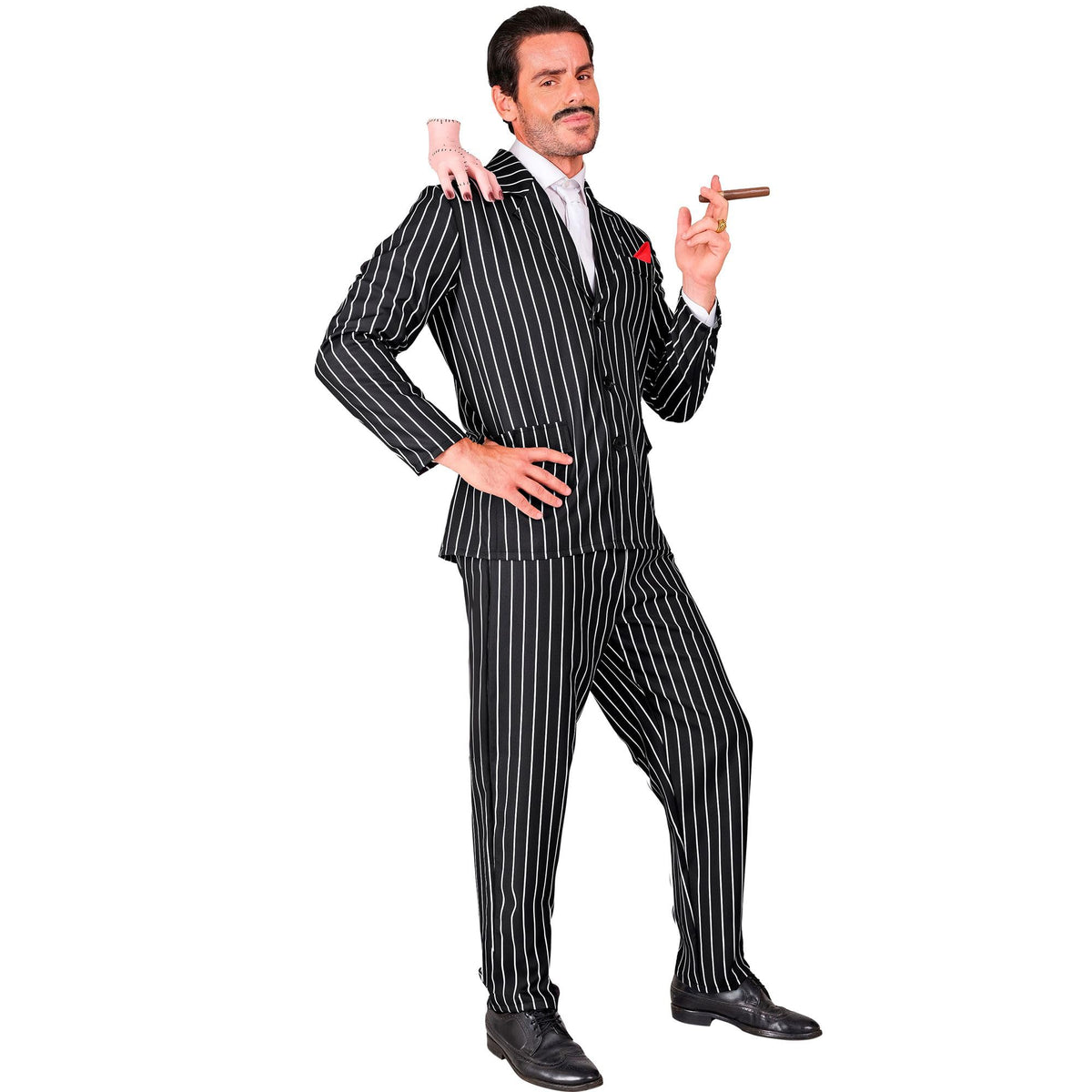 A man styled as Gomez Addams wearing a black and white pinstripe suit and white tie, posing with a prop cigar in one hand and a disembodied prop hand sitting on his shoulder.