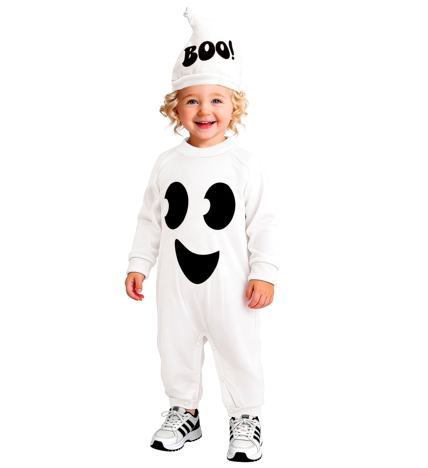 A young child standing and smiling happily while wearing a cozy all-white ghost Halloween jumpsuit with an oversized printed friendly face, paired with a matching pointed white hat that reads "BOO!".