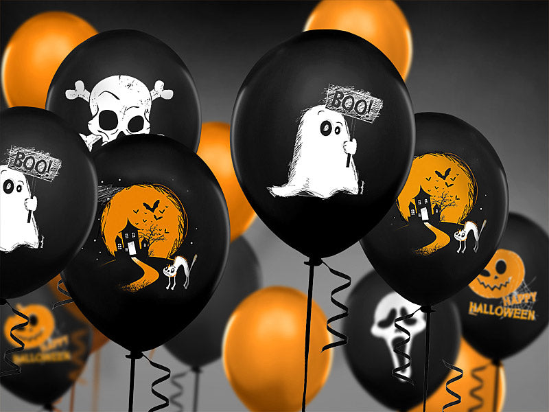 An image of a cluster of Halloween-themed balloons, featuring a mix of black and orange balloons. The black balloons are printed with various spooky designs, including a friendly ghost holding a "BOO!" sign, a skull and crossbones, and a haunted house scene with a cat and bats. The orange balloons are plain.