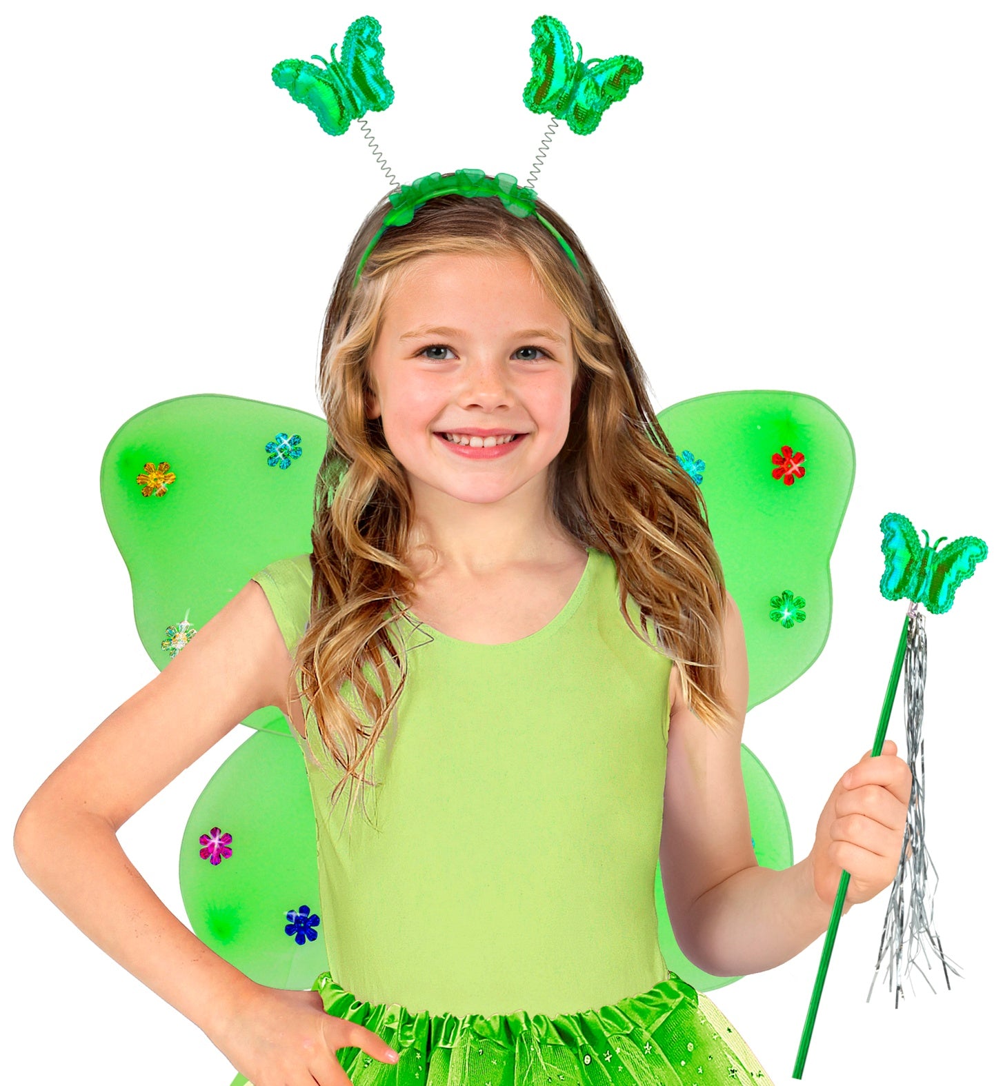 A smiling child dressed in a bright green butterfly fairy costume, wearing green wings decorated with colorful flowers, a bouncy butterfly headband, and holding a matching green magic wand with silver tassels.