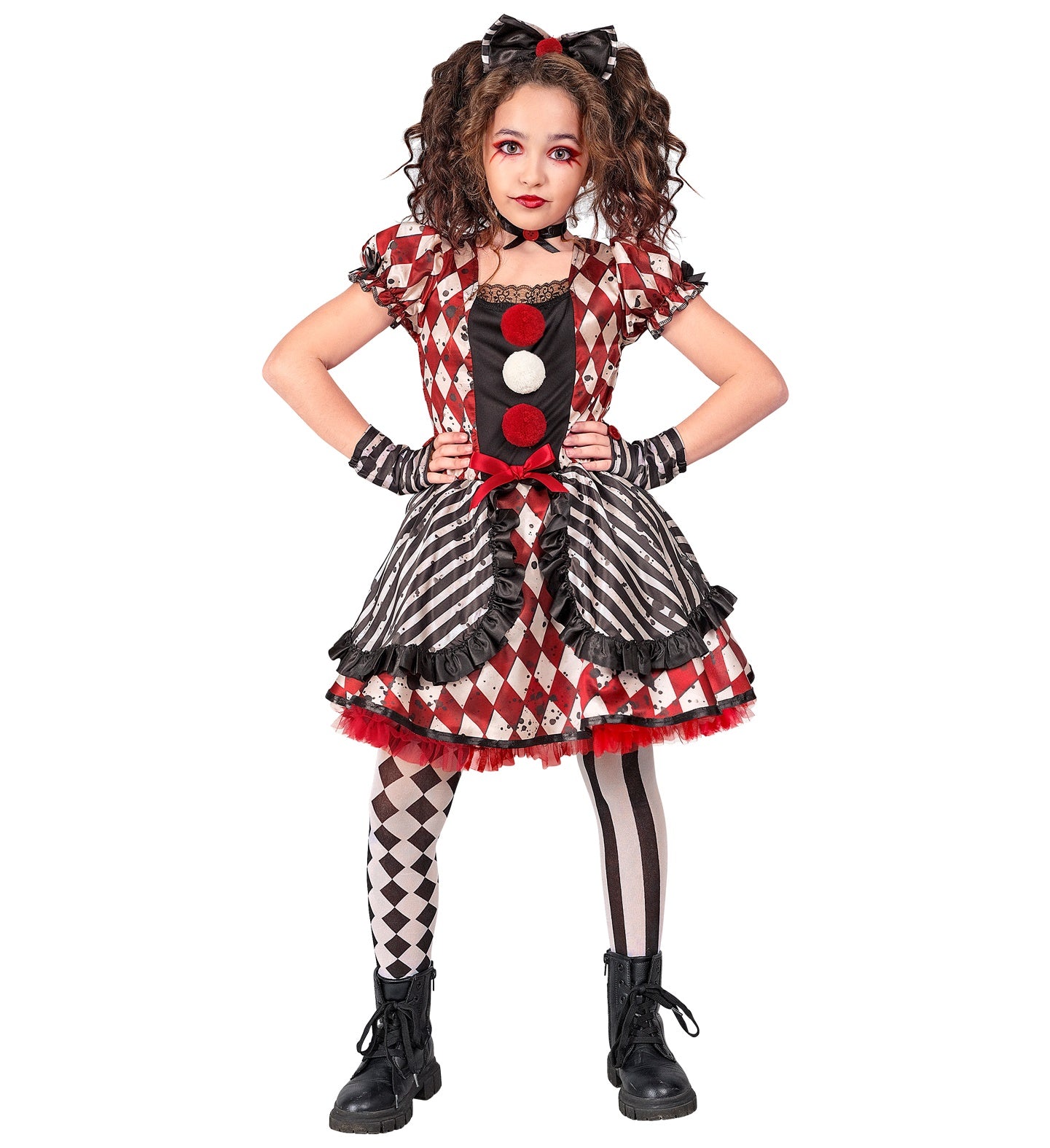 A child posing in a Harlequin Doll Clown costume, featuring a black and red bow headband, a black choker, a red and white diamond-patterned and black and white striped dress with red pom-poms, black and white patterned tights, black boots, and matching striped glovelettes. The child has dramatic makeup around the eyes and red lipstick.
