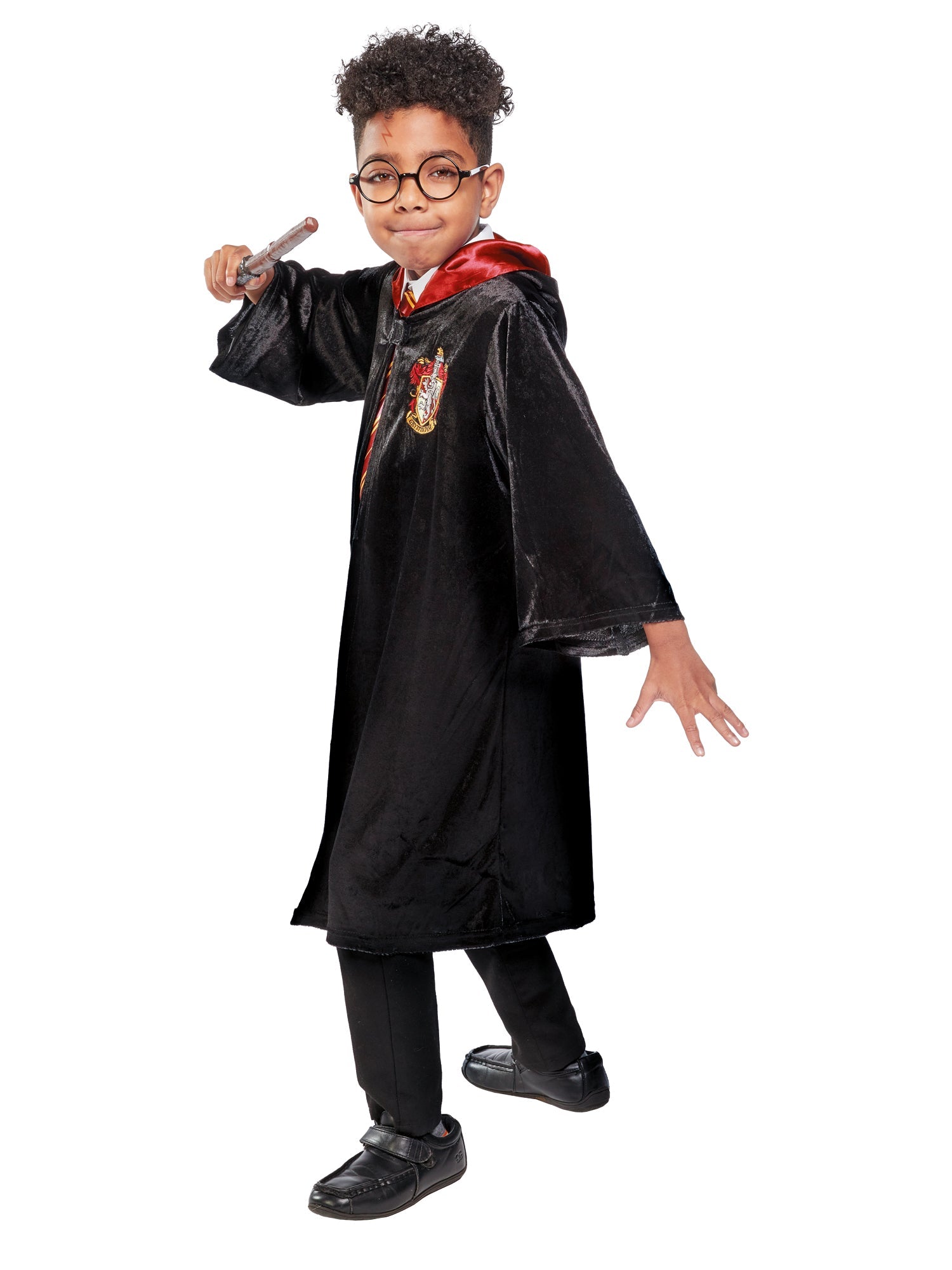 Child modelling an official Harry Potter Gryffindor robe with a red satin-lined hood and house crest.