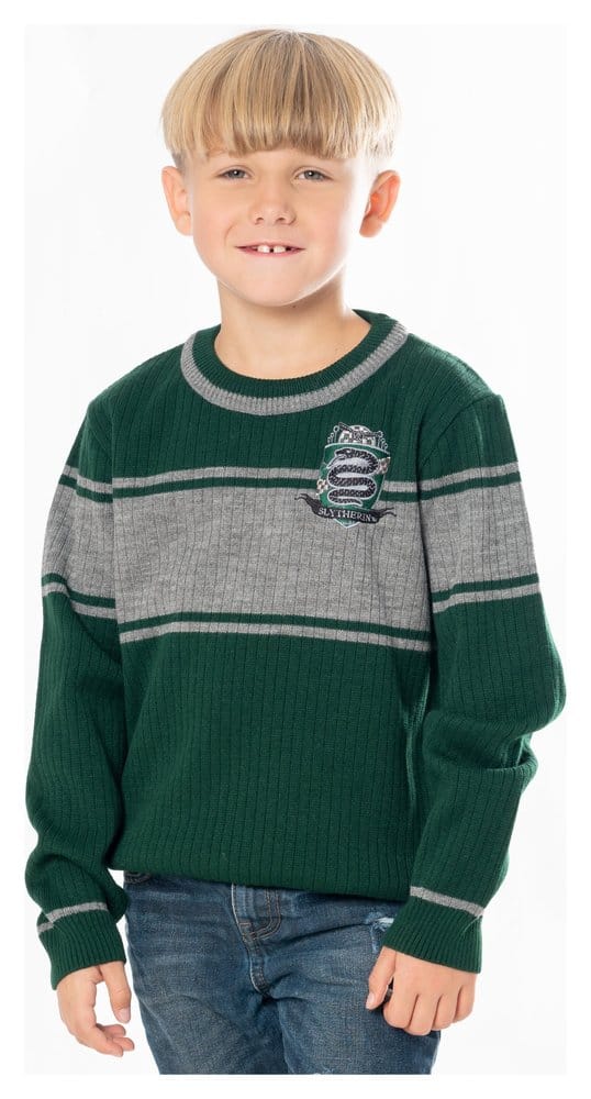 A child posing in a high-quality kids' Harry Potter Slytherin sweater, showing the classic green and silver-grey block stripes and the woven house crest on the chest.