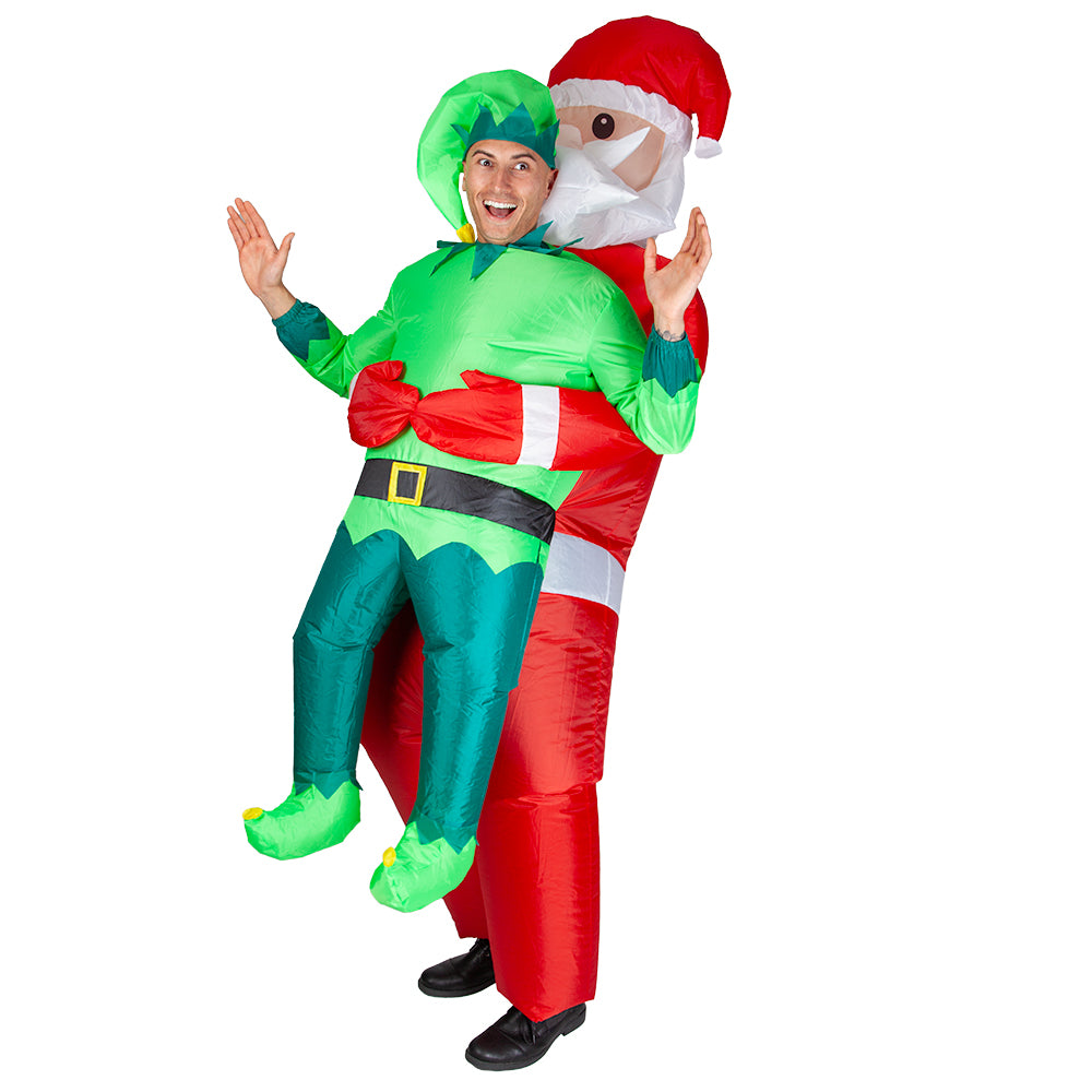 A man wearing an inflatable costume that gives the illusion of being carried by Santa Claus, showing the elf's green suit and the red Santa suit base.