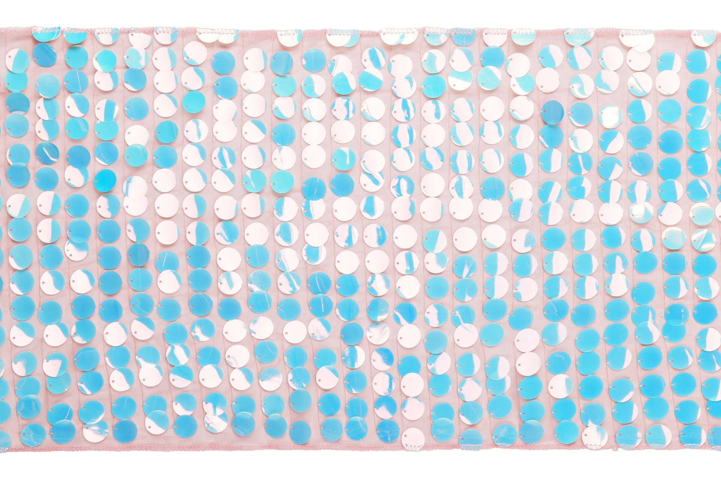 A close-up texture shot of an iridescent sequin table runner, featuring rows of large, round, shimmering sequins in shades of blue, pink, and white on a light pink mesh fabric background.