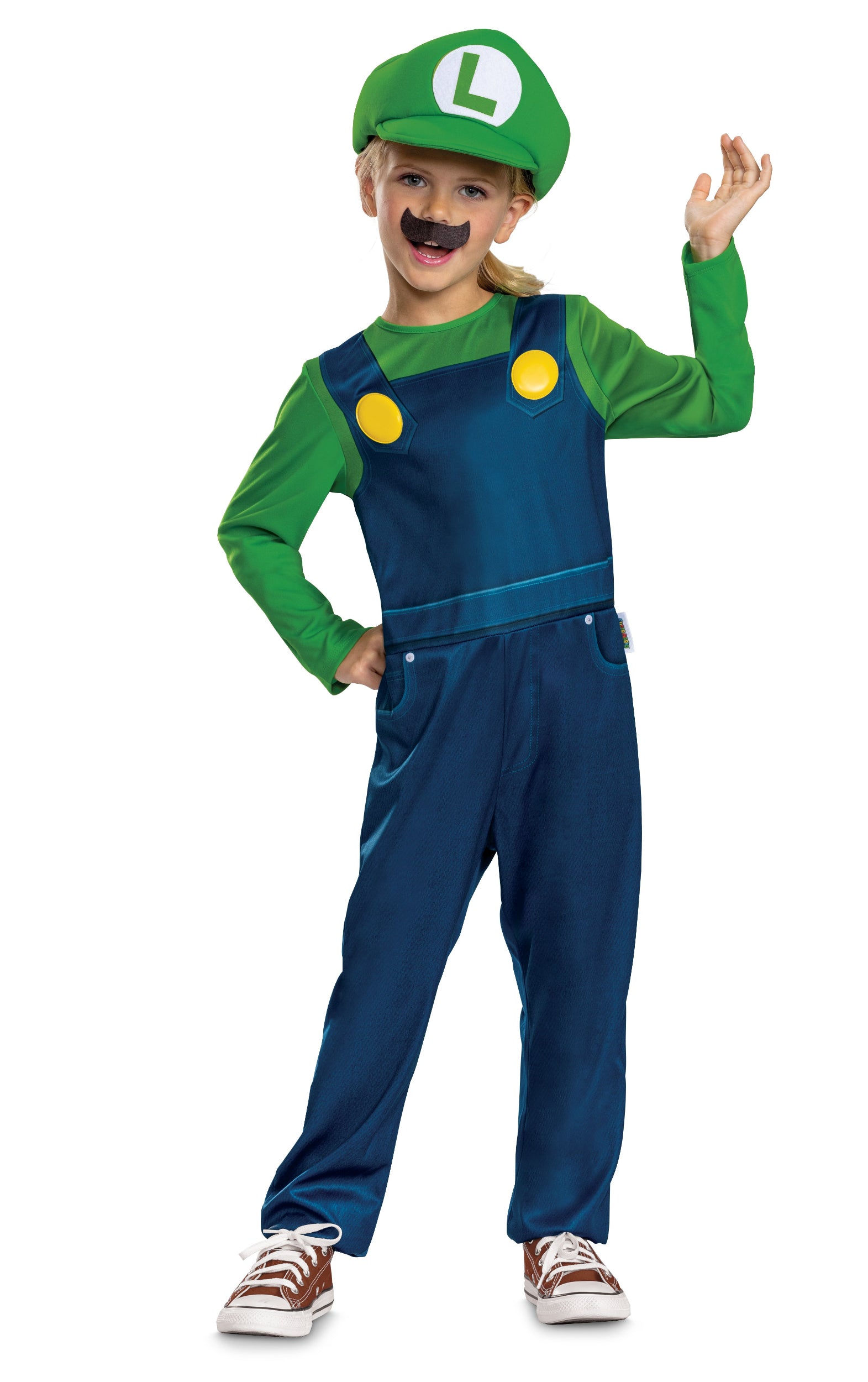 A girl wearing an officially licensed Luigi costume featuring a green and blue one-piece jumpsuit, green 'L' hat, and a faux moustache, waving playfully.