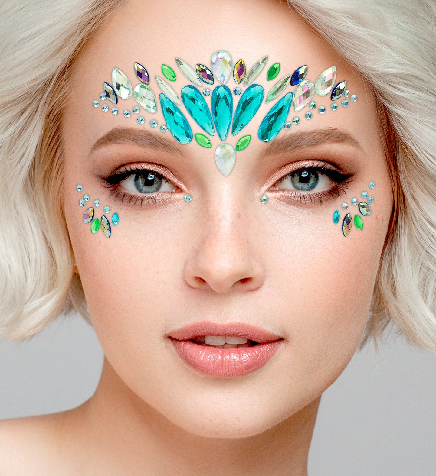 Close-up of a symmetrical teal and green crown-style face jewel arrangement for a mermaid costume.