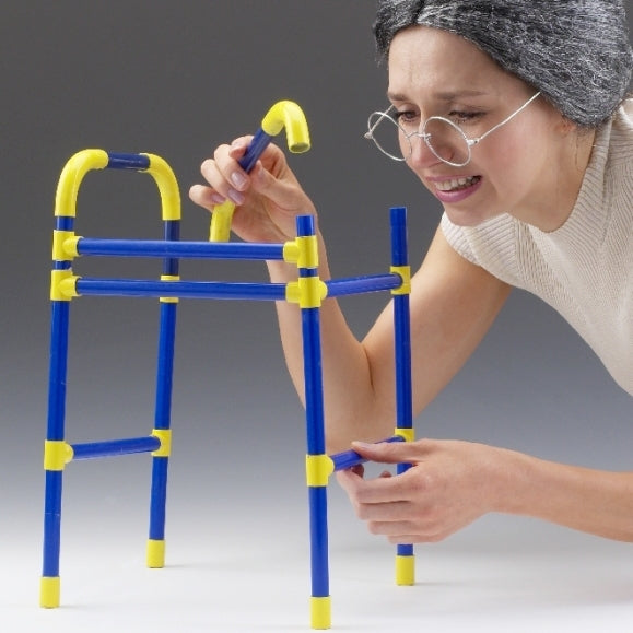 An older woman laughing while building a blue and yellow zimmer frame puzzle frame with yellow sand timer.