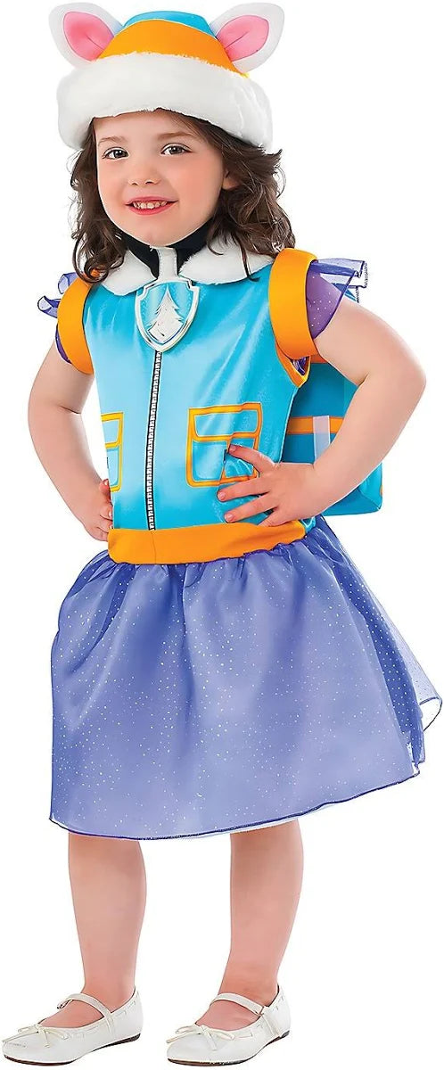 A child posing happily in a full kids' Paw Patrol Everest costume, wearing a blue and orange vest top with a sparkling purple skirt, a teal husky ear hat, and a blue rescue backpack.
