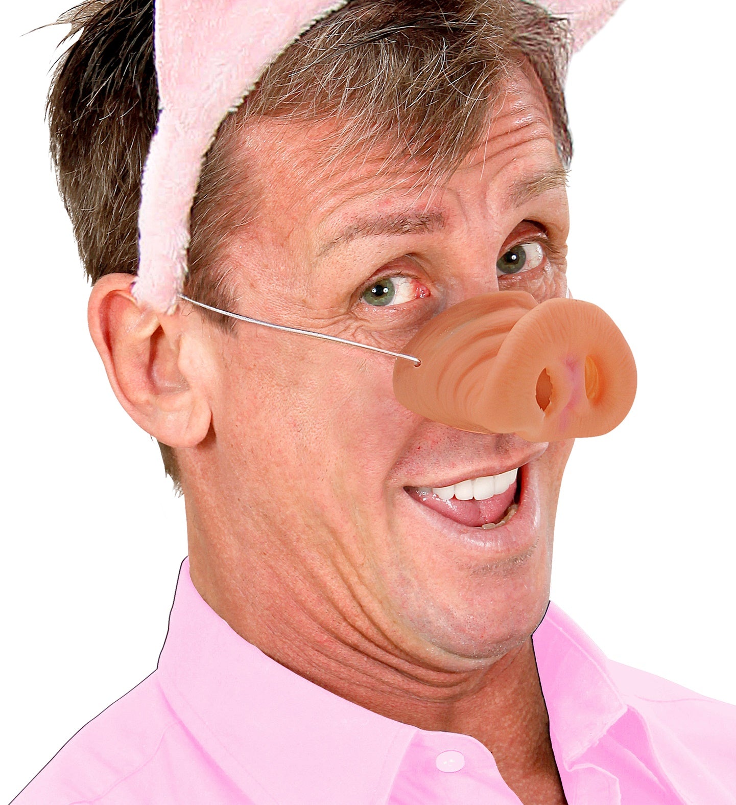 A smiling man wearing a pink pig nose with an elastic strap, paired with a pig ears headband.