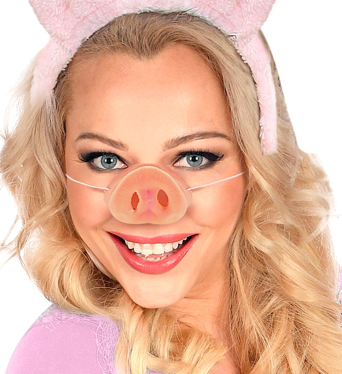 A woman with blonde hair smiling while modeling a funny pig nose and a pink pig ears headband.