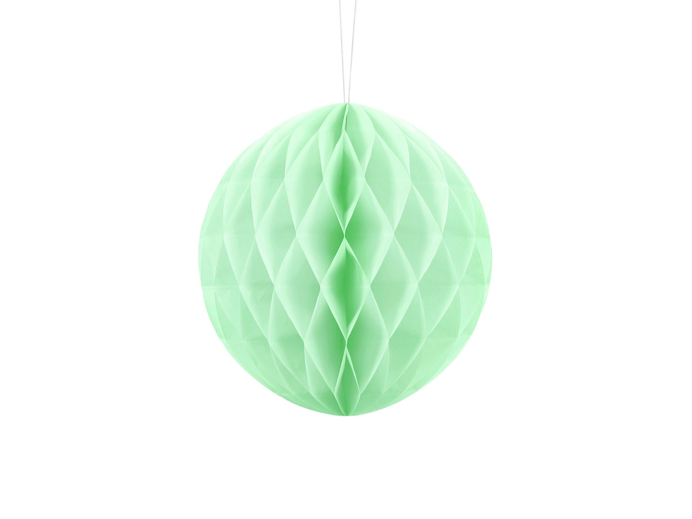 A 20cm hanging paper honeycomb ball in a soft, pastel pistachio (mint green) colour.