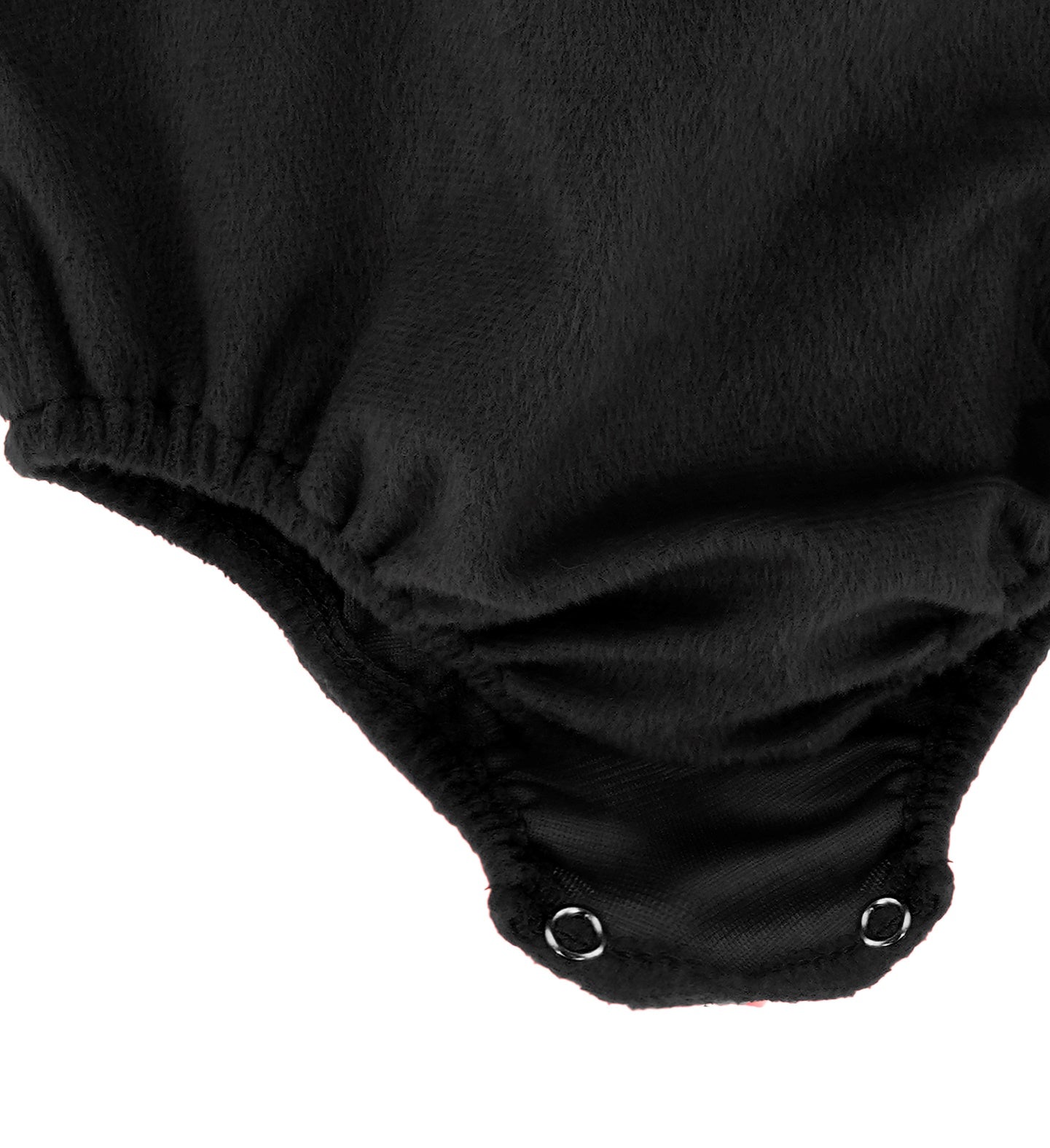 A close-up of the plush black jumpsuit, showing the snap fasteners and elasticated leg openings at the crotch area.