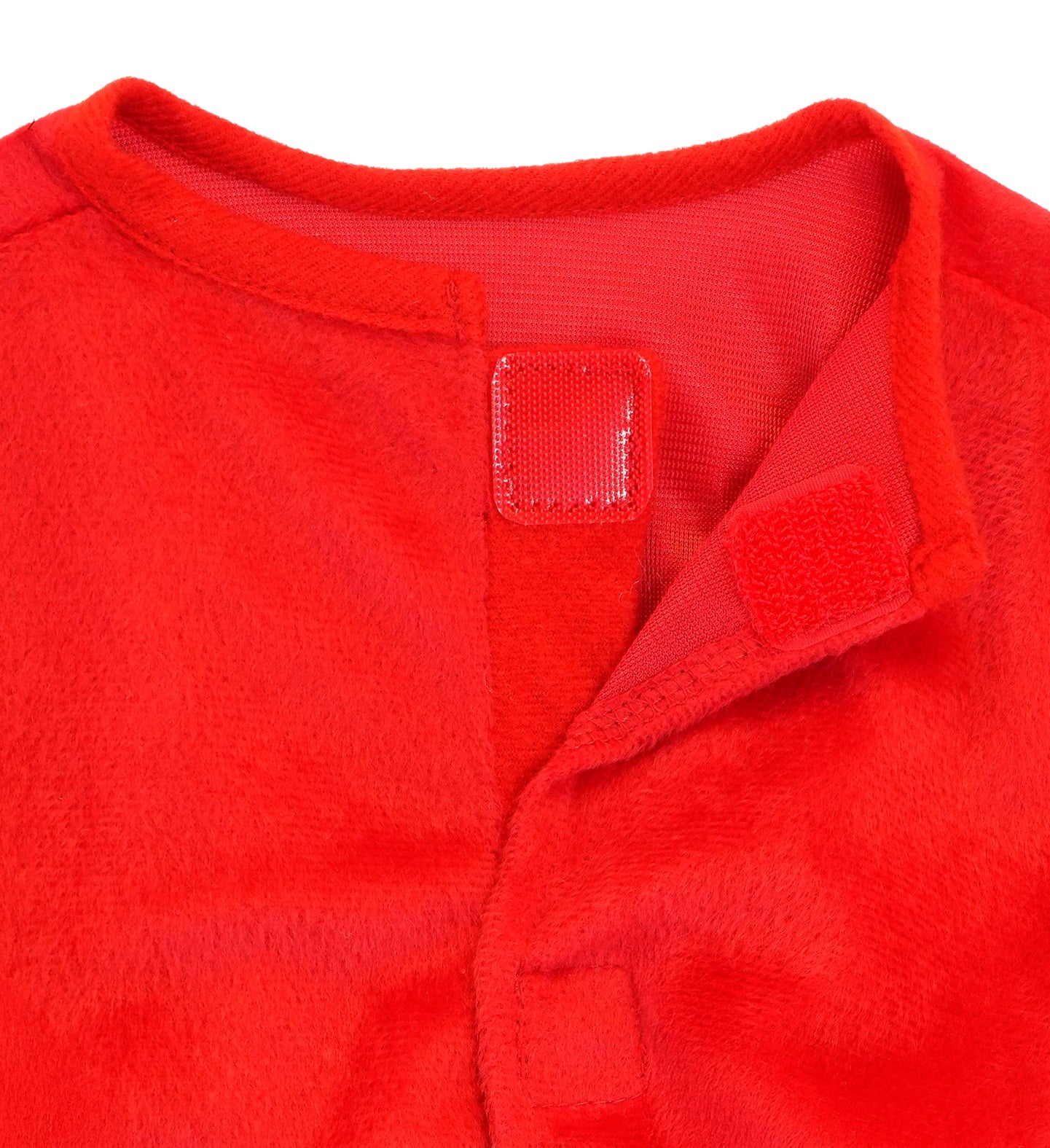 A close-up of the neck area of the red plush jumpsuit, showing the red velcro closure at the back.