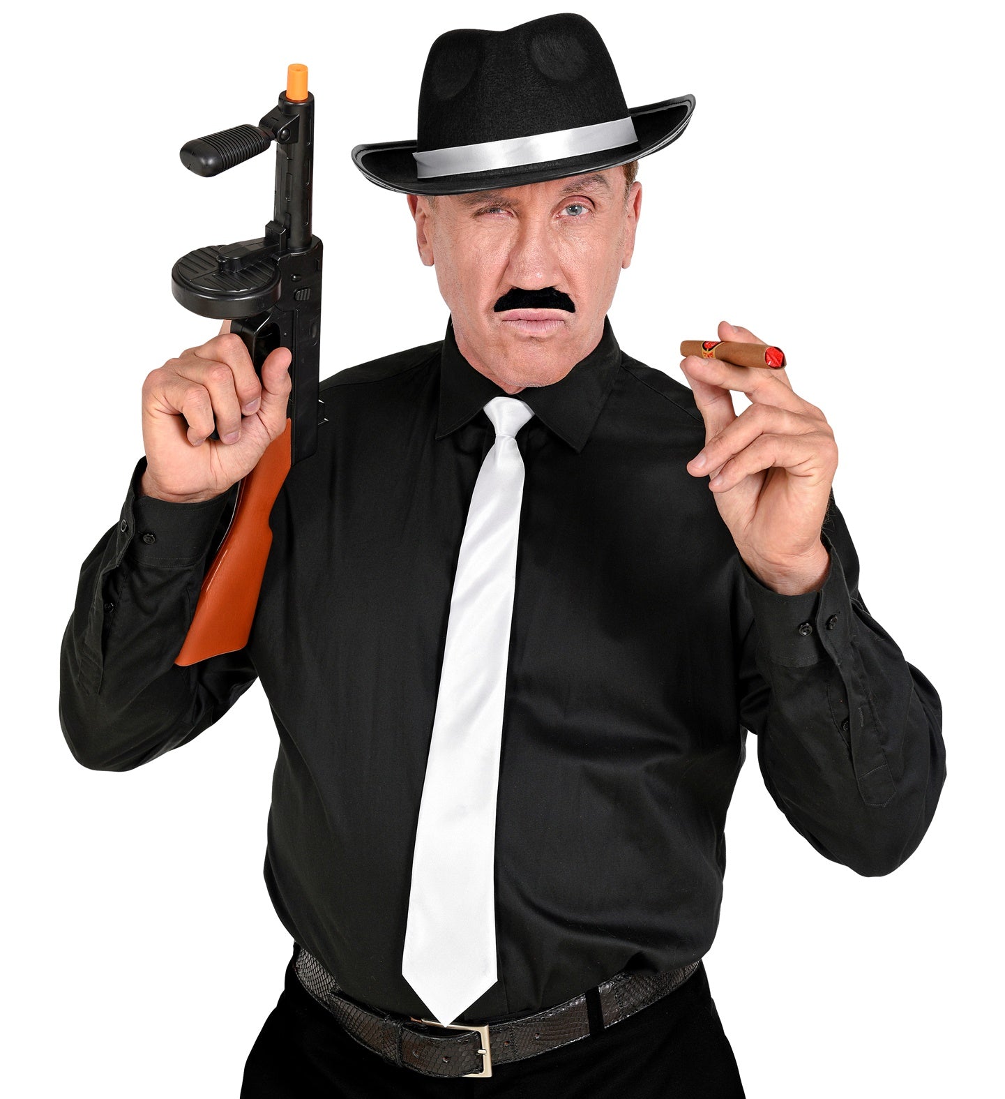 A man dressed as a 1920s mobster wearing a black shirt, white tie, and black fedora, holding a prop Tommy gun and a cigar while showing off a black moustache.