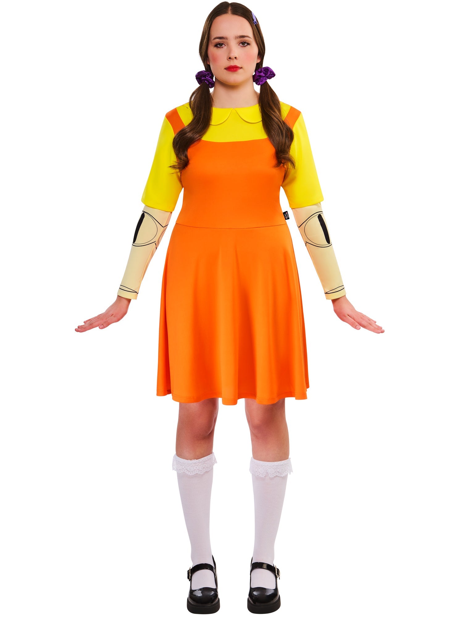 A woman smiles while modeling the Game Doll costume dress with white knee-high socks against a white background