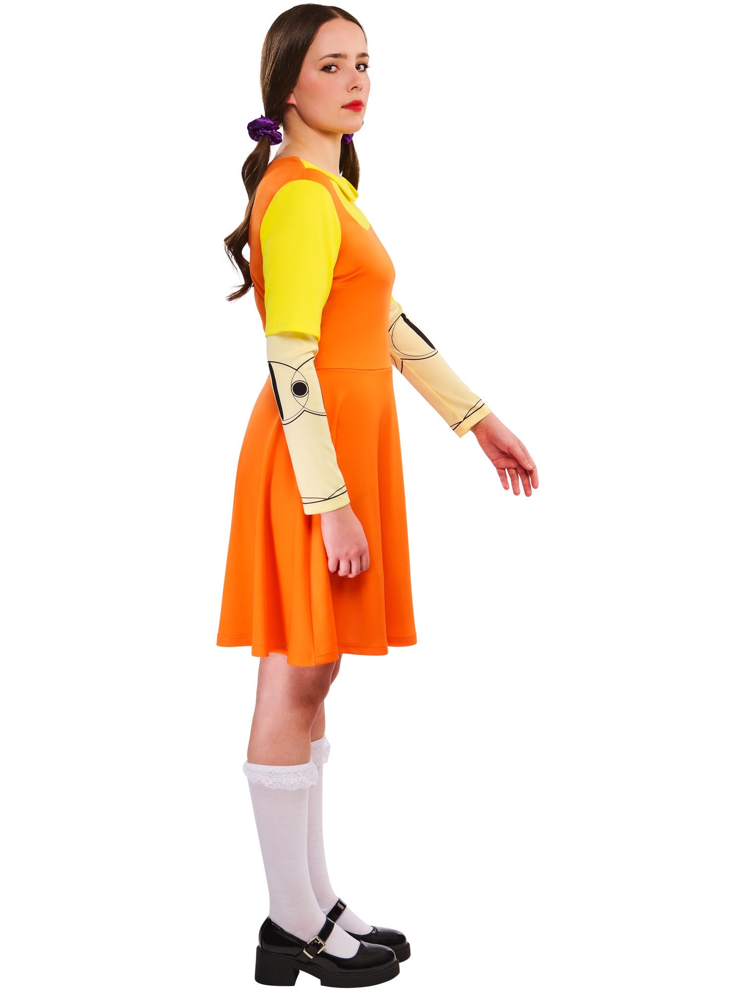 Side profile of a woman in the Game Doll costume, showing the printed joint detail on the sleeve and her hair in pigtails