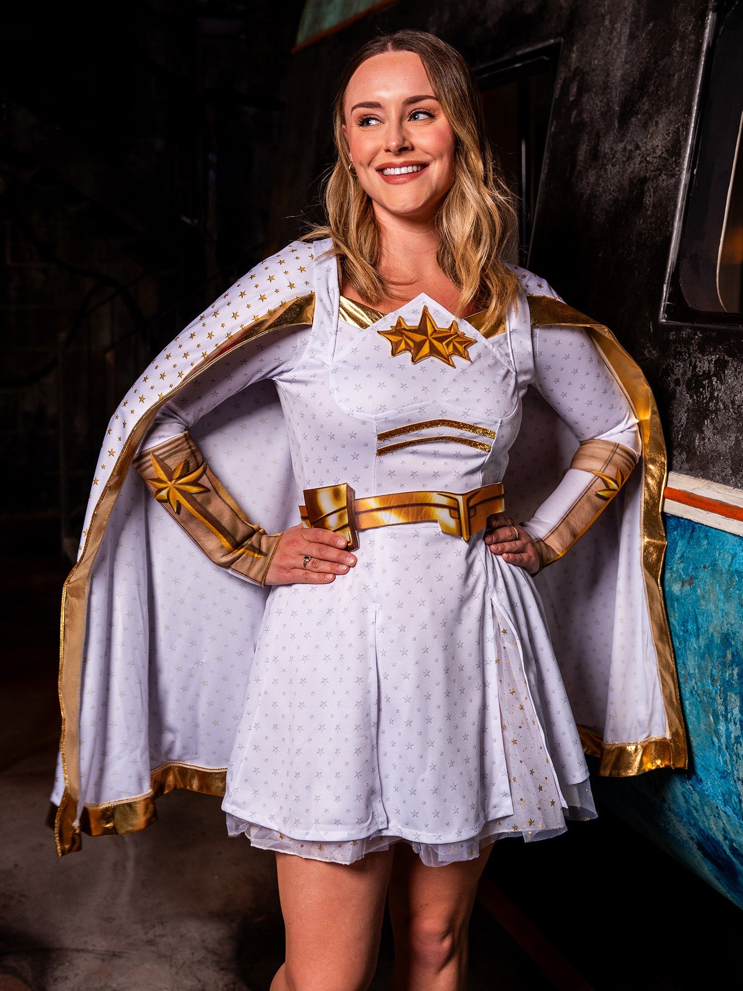 A close-up of a woman modeling the Starlight costume, showing the star details on the chest of the white and gold dress.