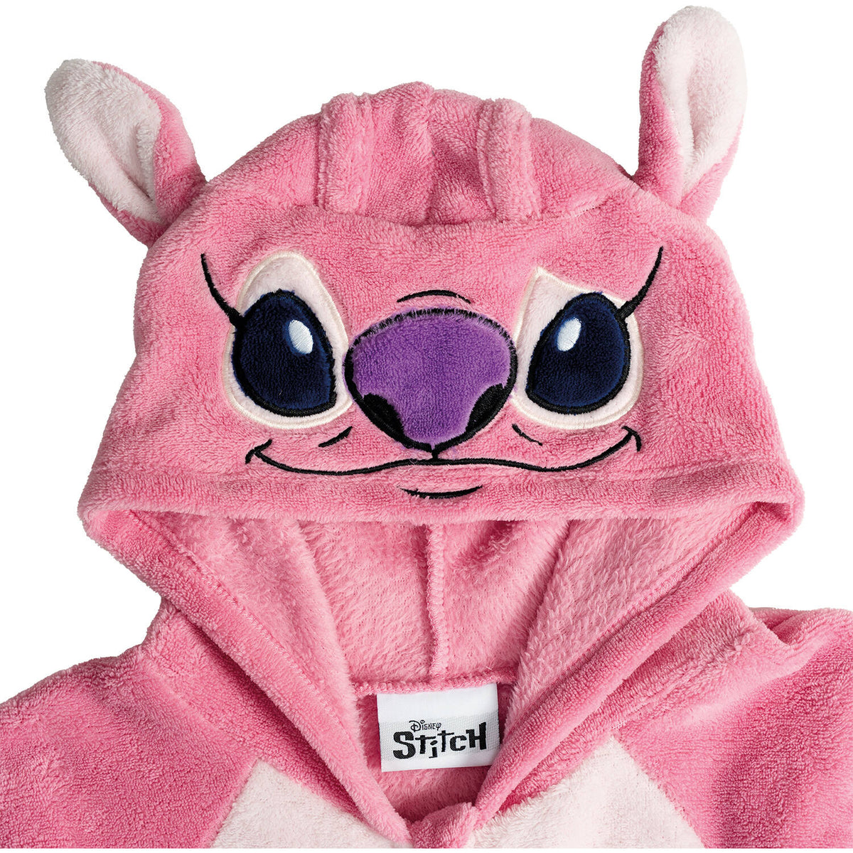 Close-up of a pink fluffy costume hood featuring an embroidered alien Stitch Angel face with large blue eyes, a purple nose, and soft pink ears