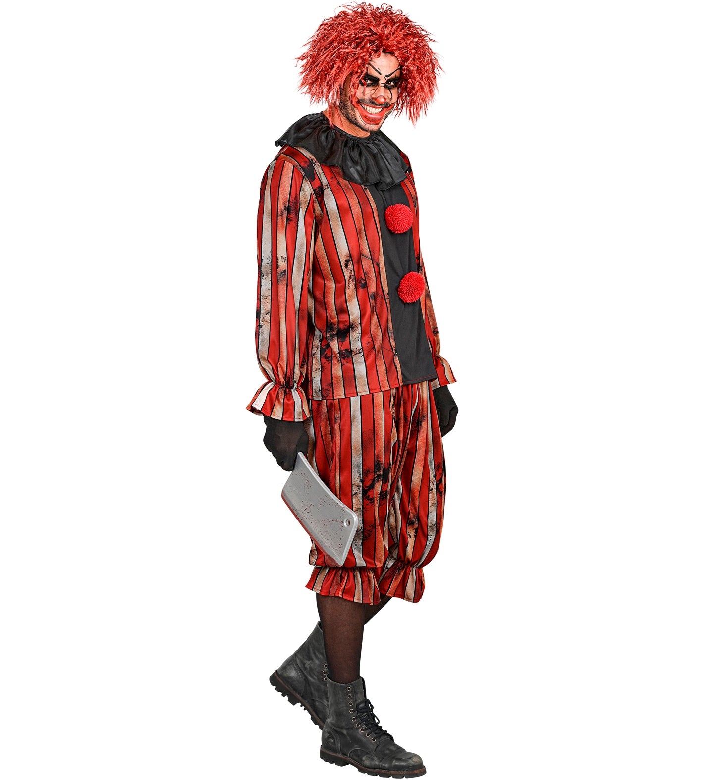 A side-profile view of a man in a wicked clown fancy dress costume looking menacingly at the camera while holding a fake bloody meat cleaver, wearing a red and black striped suit with black boots.