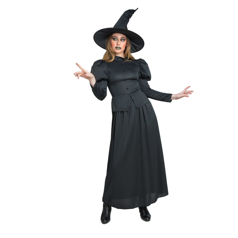 A woman in a long black witch costume with a pointy hat, gesturing as if casting a spell.