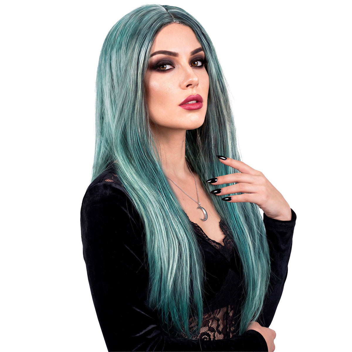 A close-up beauty shot of a woman with dramatic eye makeup modeling a long, straight teal and silver wig with a center part, wearing a black velvet top and a silver crescent moon necklace.