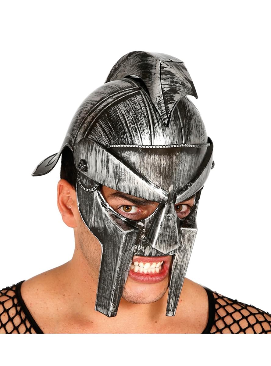 Man wearing a silver plastic Roman gladiator helmet with a face guard and crest, snarling at the camera.