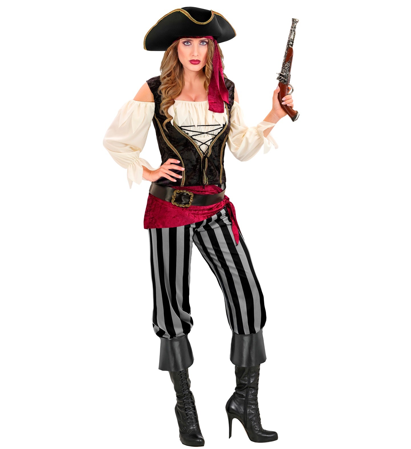 A woman posing in a Pirate Rogue costume, featuring a black tricorn hat with gold trim, a red bandana, an off-white peasant shirt with a black and gold corset-style vest, black and white striped puffy pants, a red sash, a black belt with a gold buckle, and black boots, holding a prop flintlock pistol.