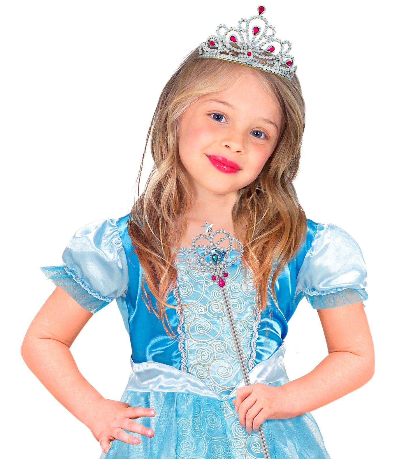 A young child with wavy hair, wearing a light blue princess dress and a silver tiara with red gems, smiling and holding a silver magic wand with colorful gems and a star at the top.