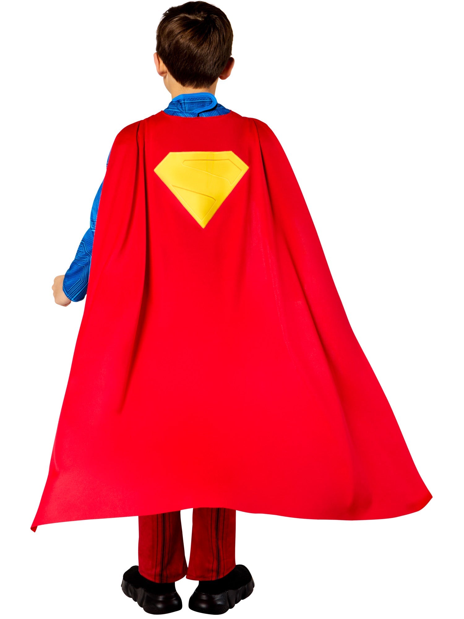 A back view of a child in a deluxe Superman costume, showing the red cape with the yellow "S" emblem hanging down.