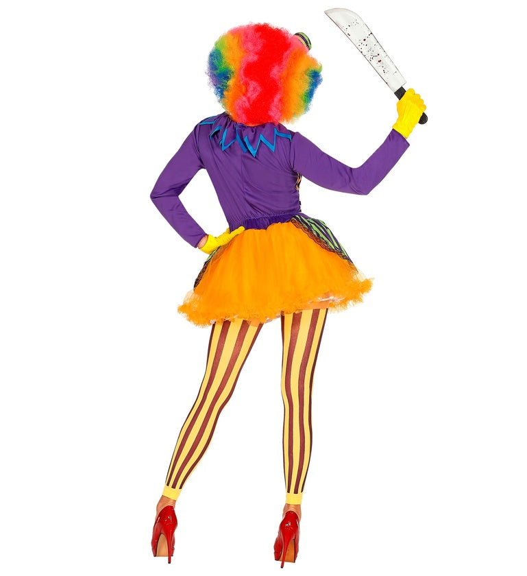 A back view of a person in a colorful clown costume, holding a toy machete. The costume includes a purple top, an orange tutu skirt, and yellow and brown striped leggings, with a rainbow wig visible.