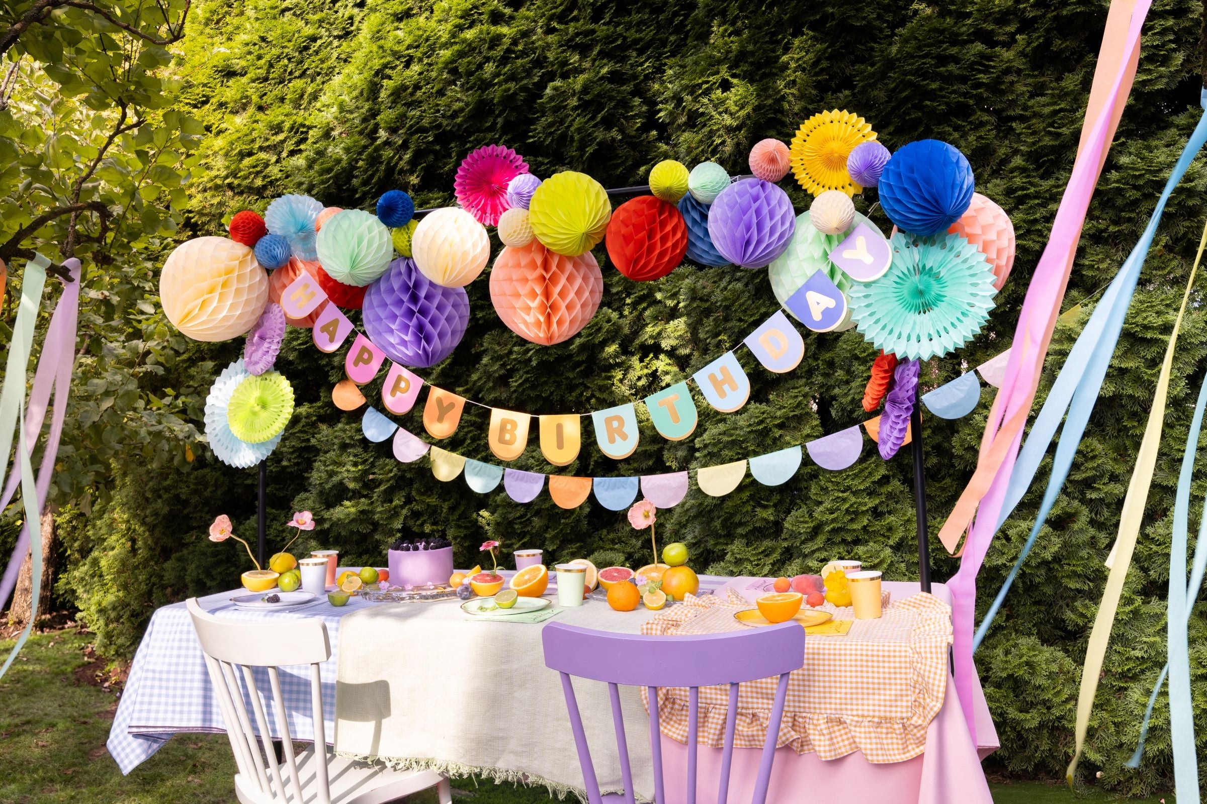 A table with Party Decorations with Banners, Bunting & honeycomb Decor